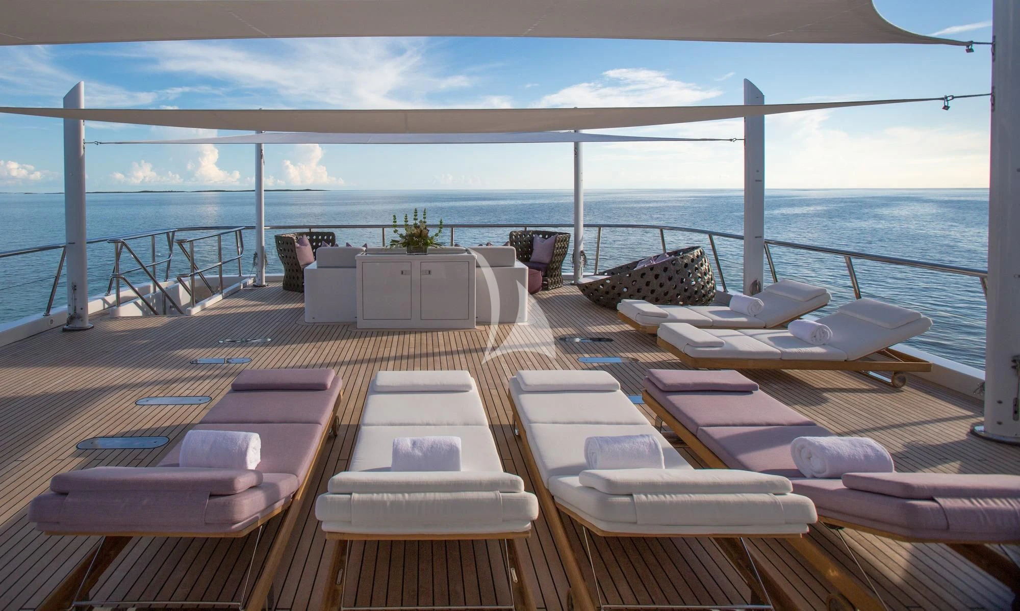 a deck with a view of the ocean and the ocean aboard DREAM Yacht for Sale