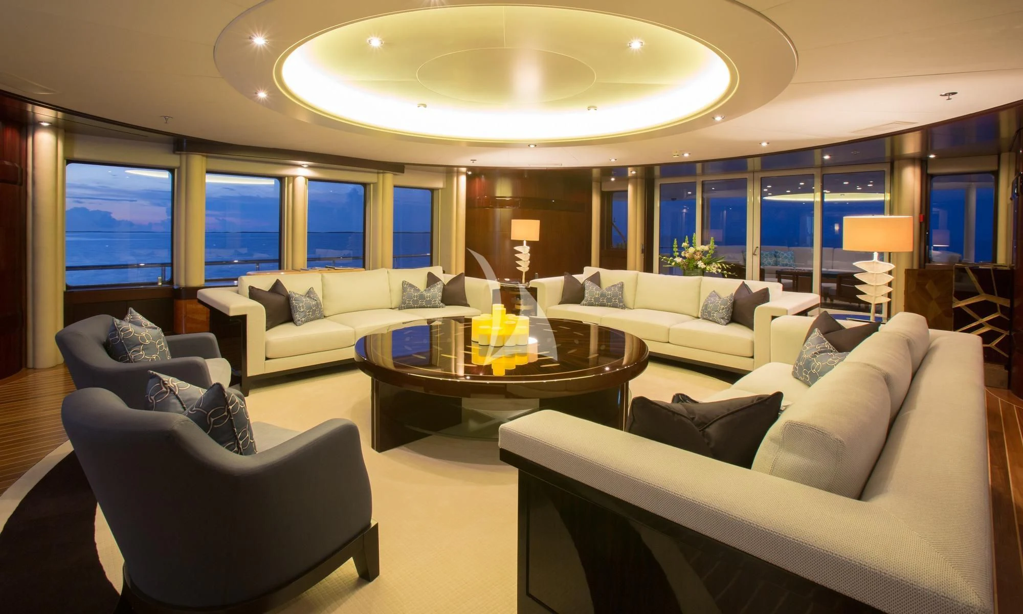 a living room with a large chandelier aboard DREAM Yacht for Sale