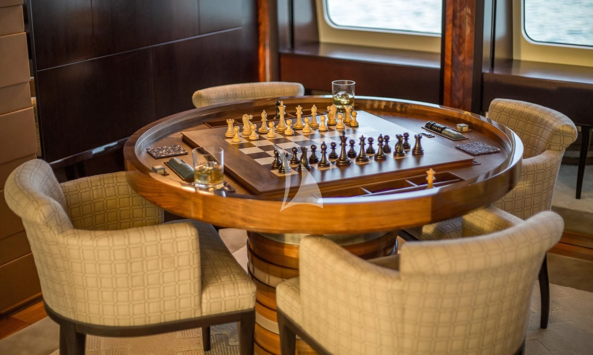 a wooden table with a board game on it aboard DREAM Yacht for Sale