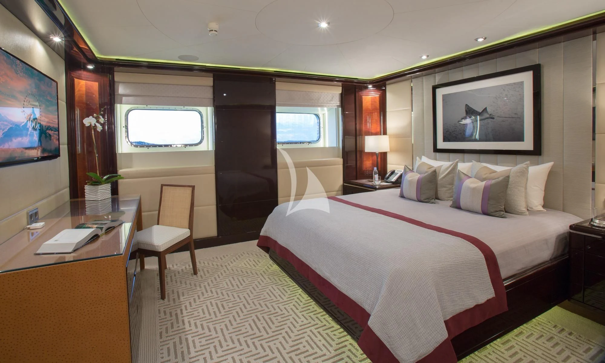 a hotel room with a bed and desk aboard DREAM Yacht for Sale