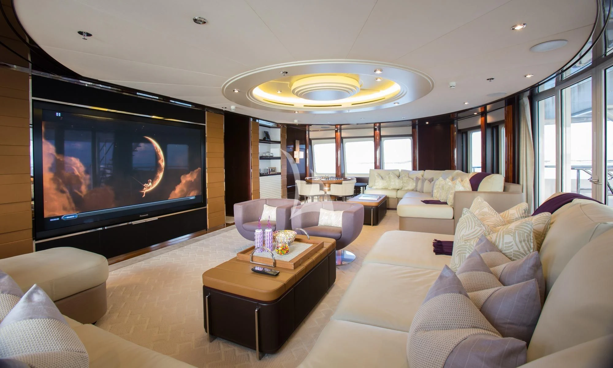 a living room with a large screen aboard DREAM Yacht for Sale