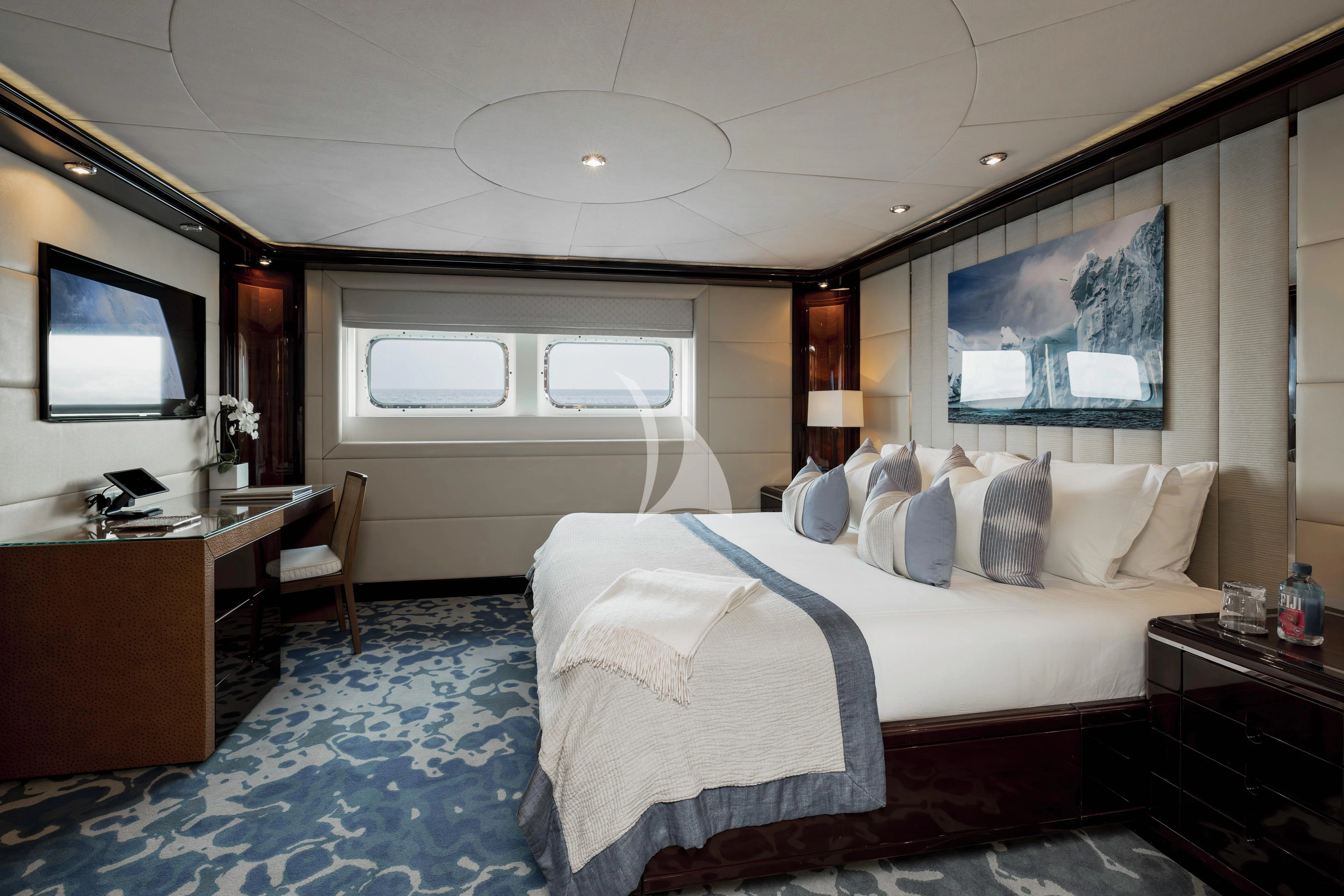 a bedroom with a bed and a television aboard DREAM Yacht for Sale