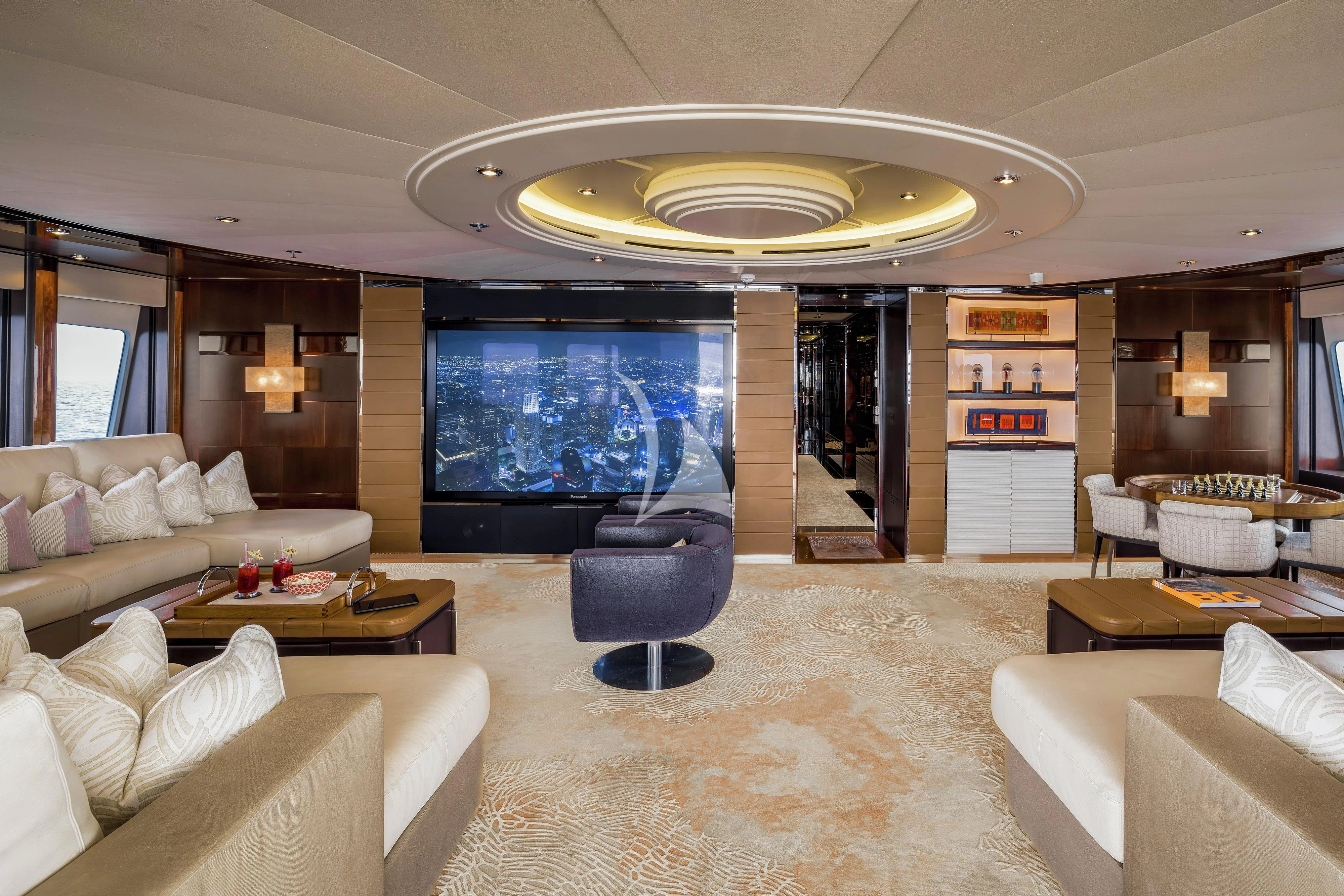 a large living room with a large screen aboard DREAM Yacht for Sale