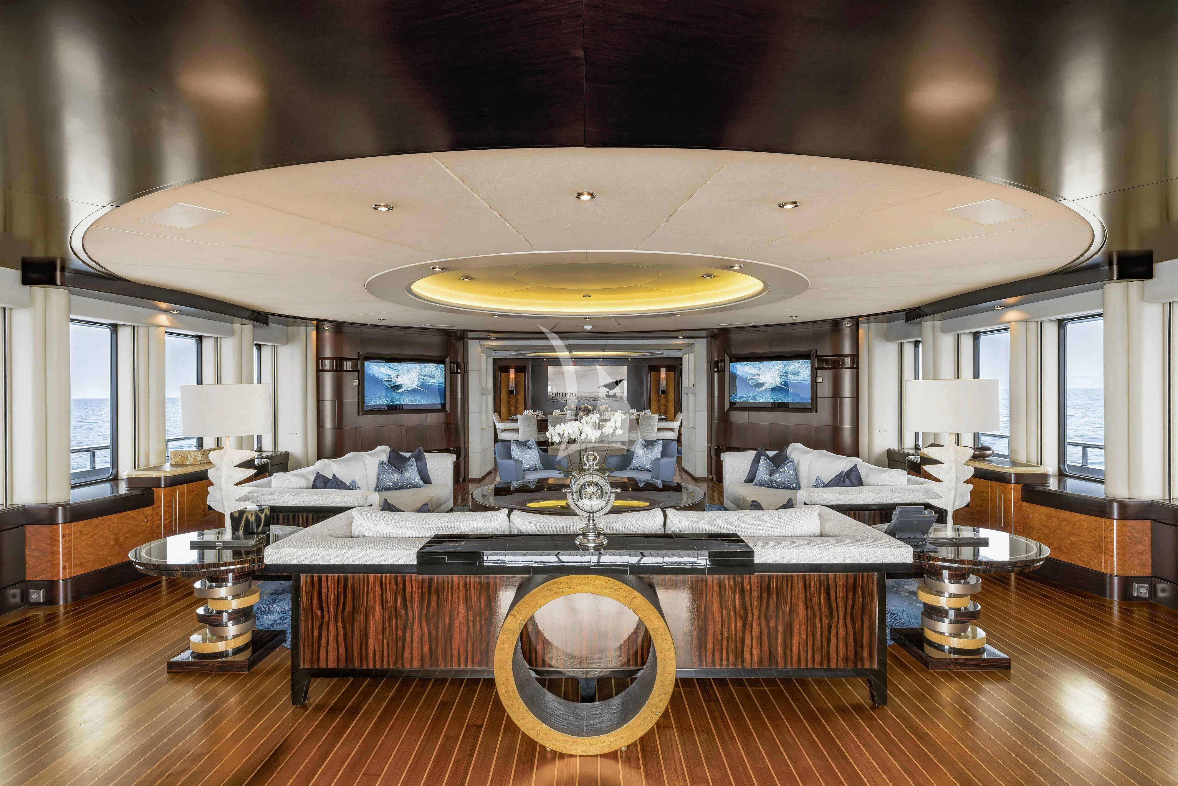 a large living room with a large chandelier aboard DREAM Yacht for Sale