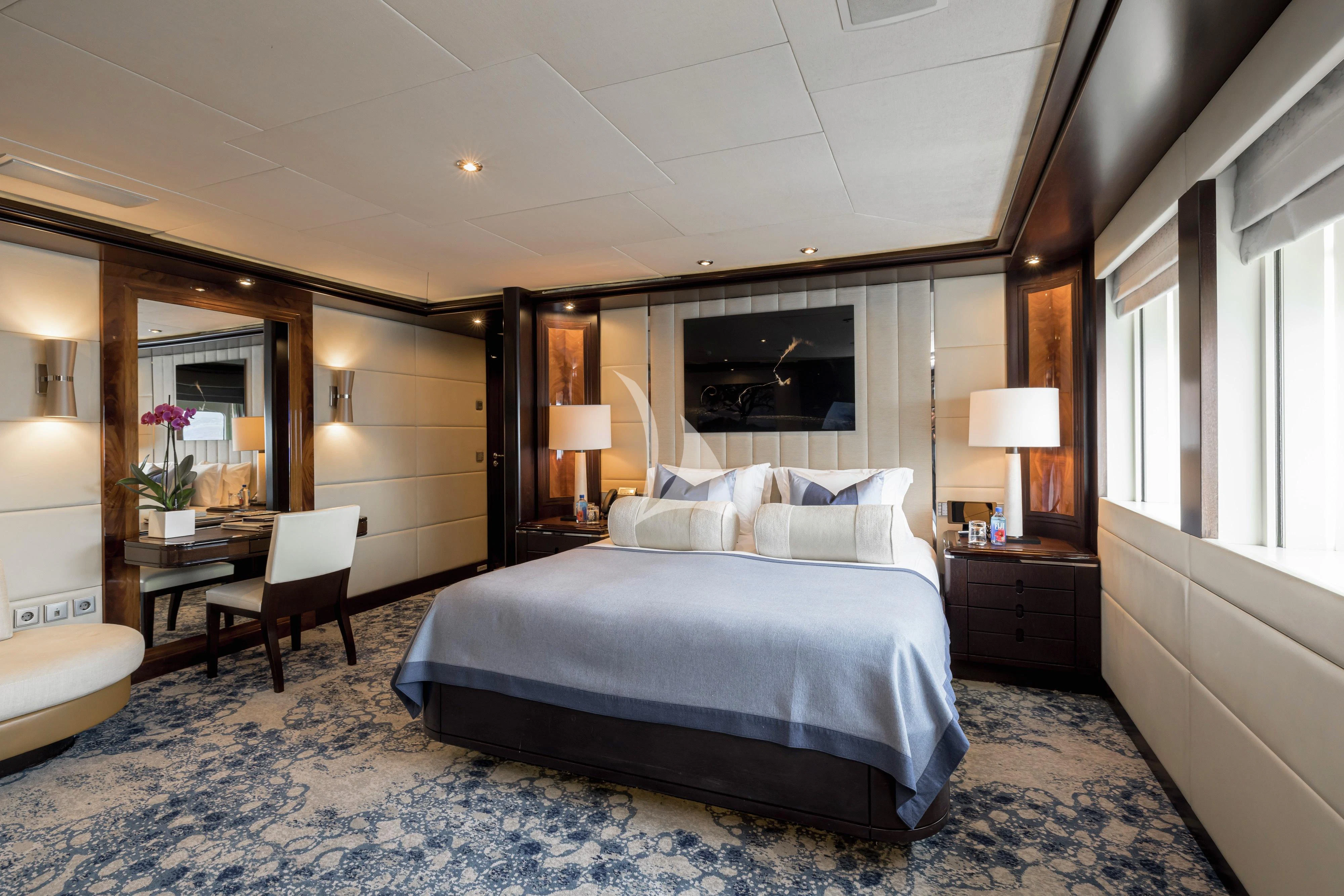 a bedroom with a bed and a chair aboard DREAM Yacht for Sale