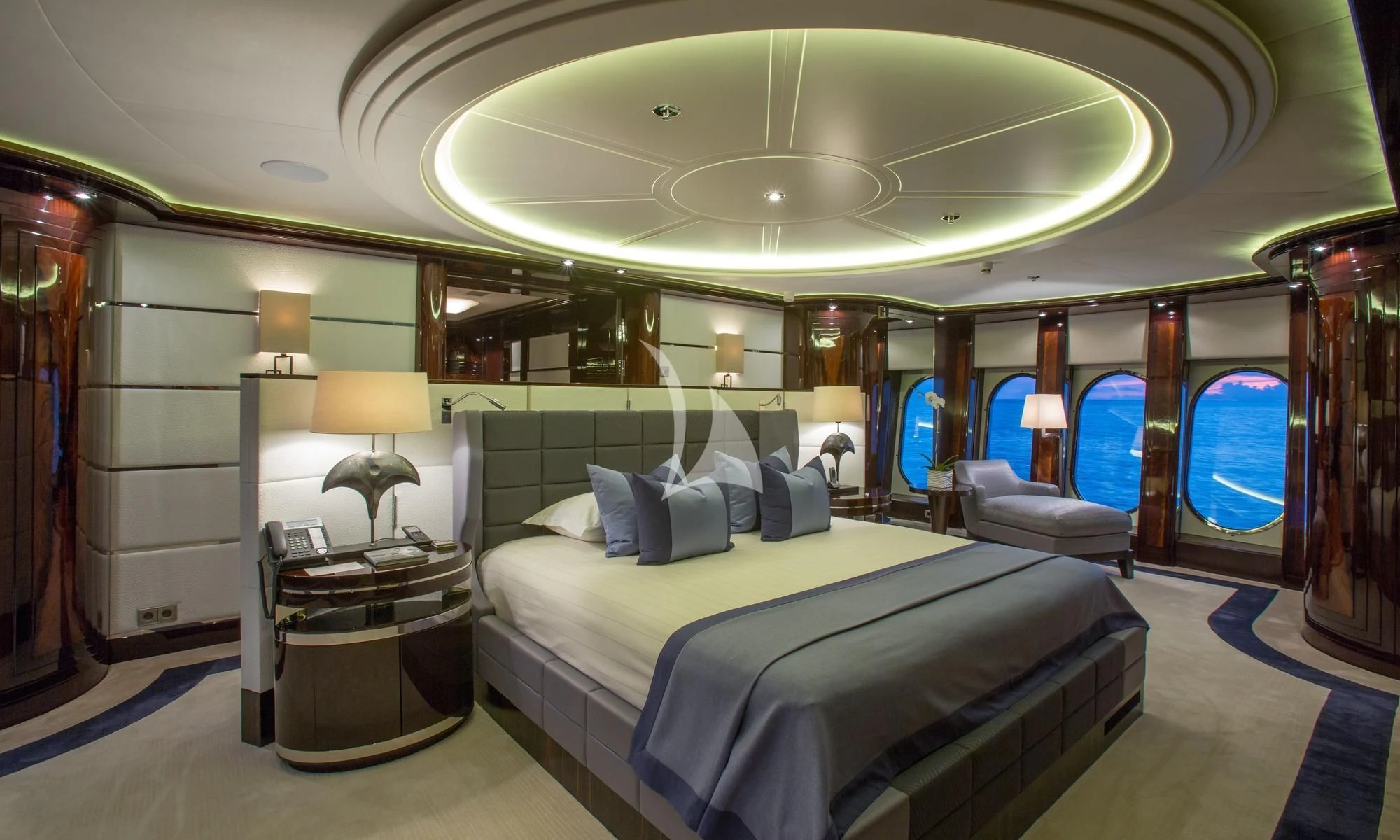a room with a bed and a lamp aboard DREAM Yacht for Sale