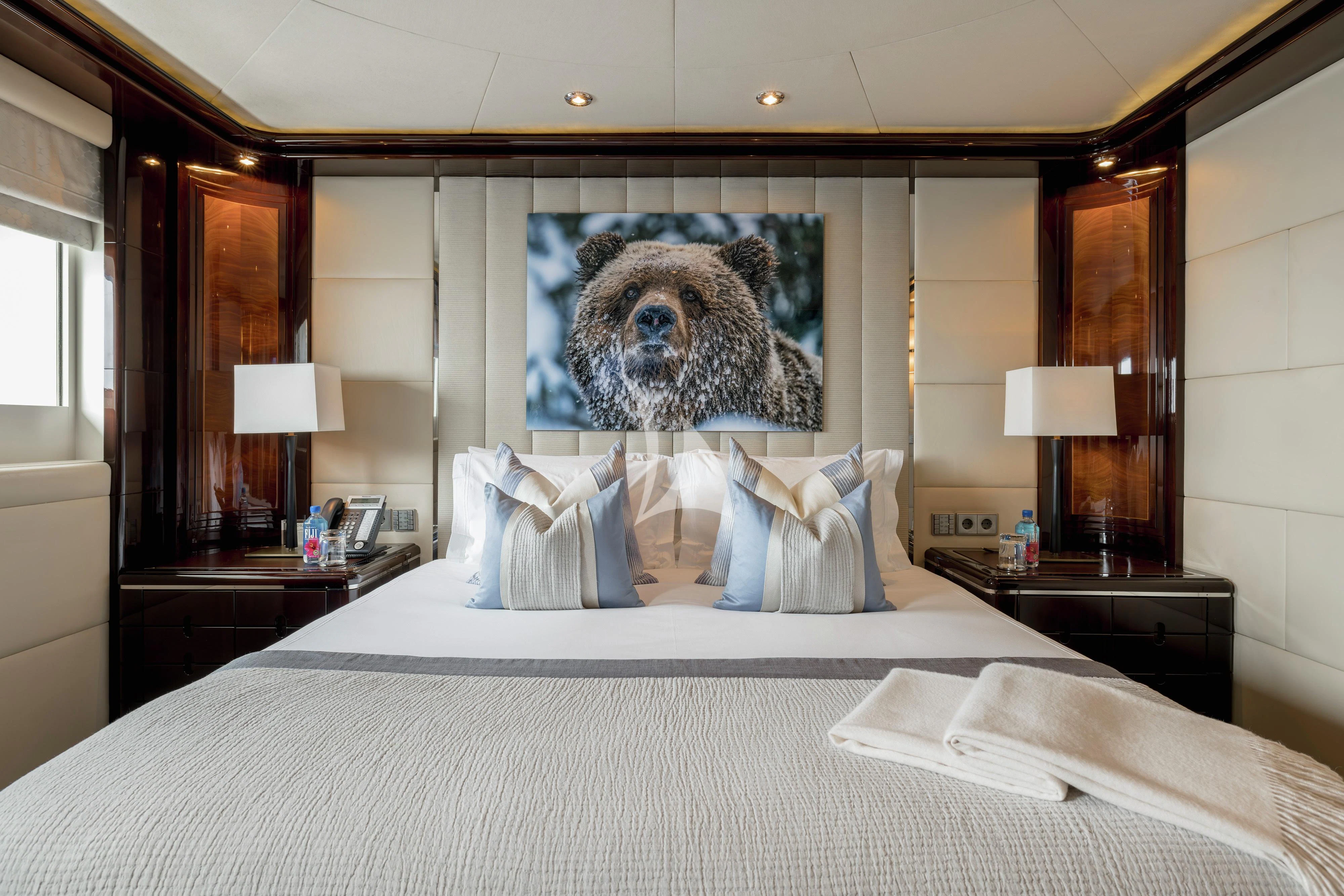 a bed with a picture on the wall aboard DREAM Yacht for Sale