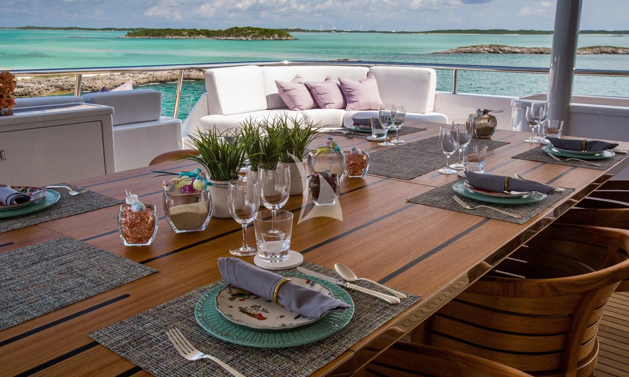 a table with plates and glasses on it aboard DREAM Yacht for Sale