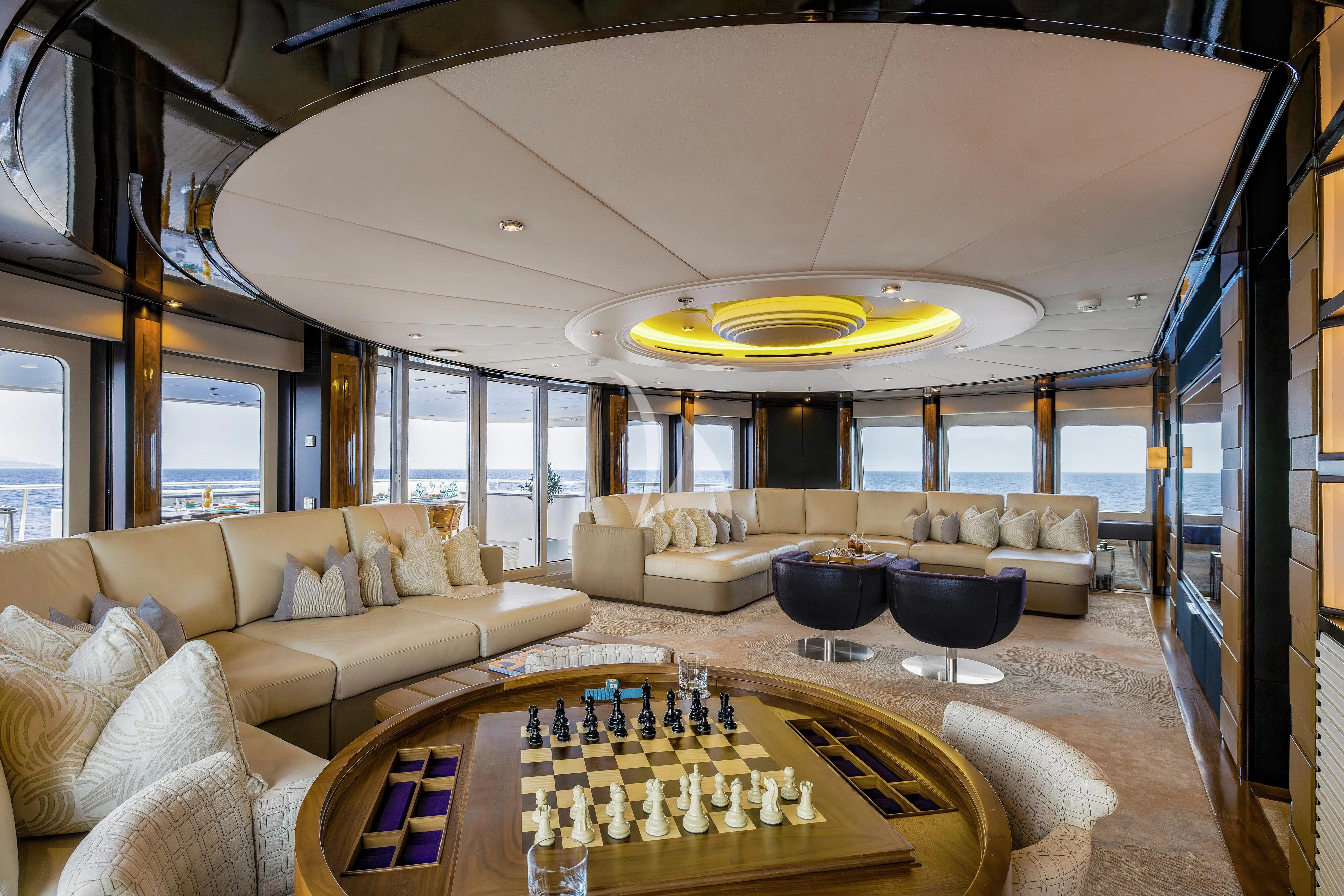 a living room with a large chandelier aboard DREAM Yacht for Sale