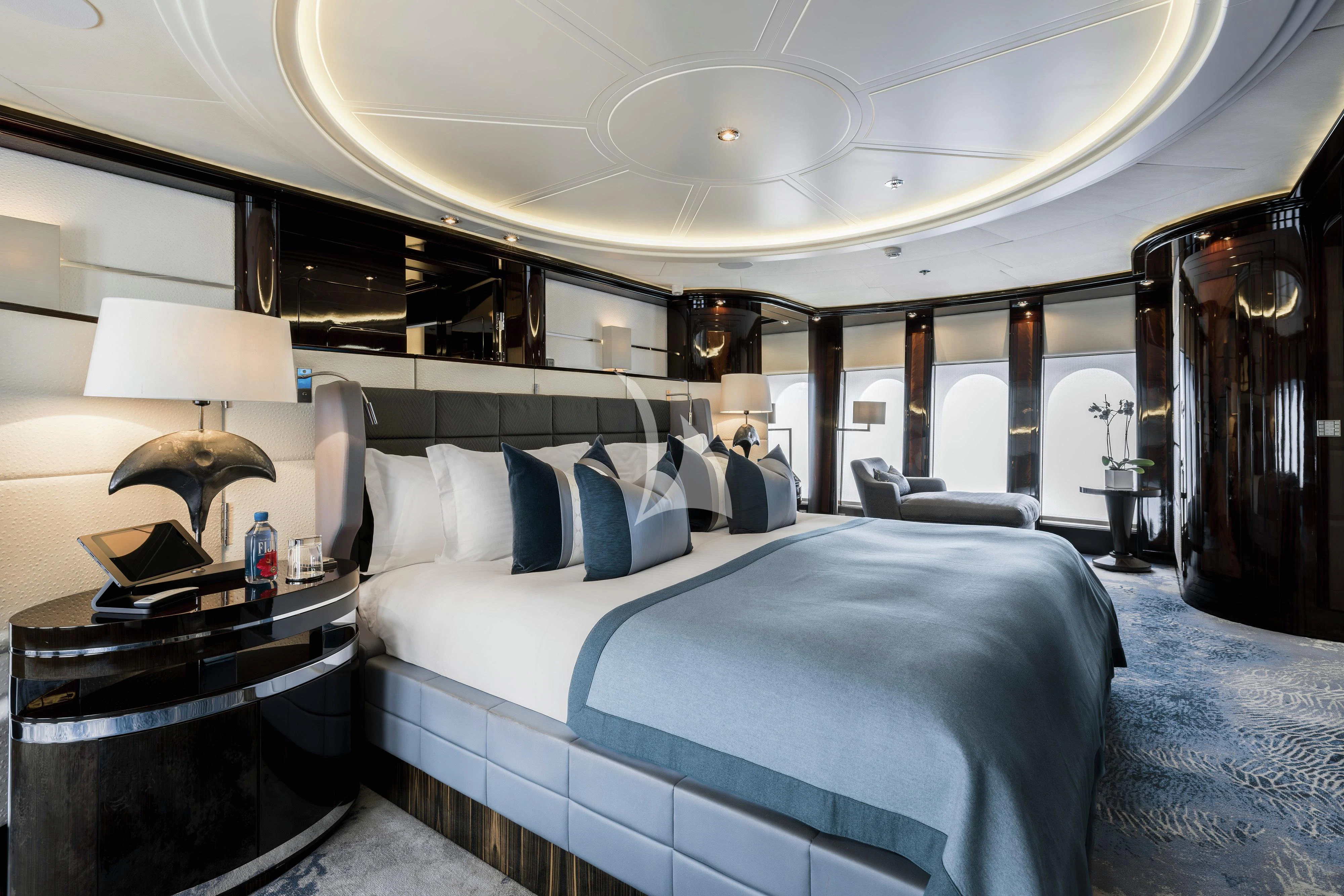 a room with a bed and a table aboard DREAM Yacht for Sale