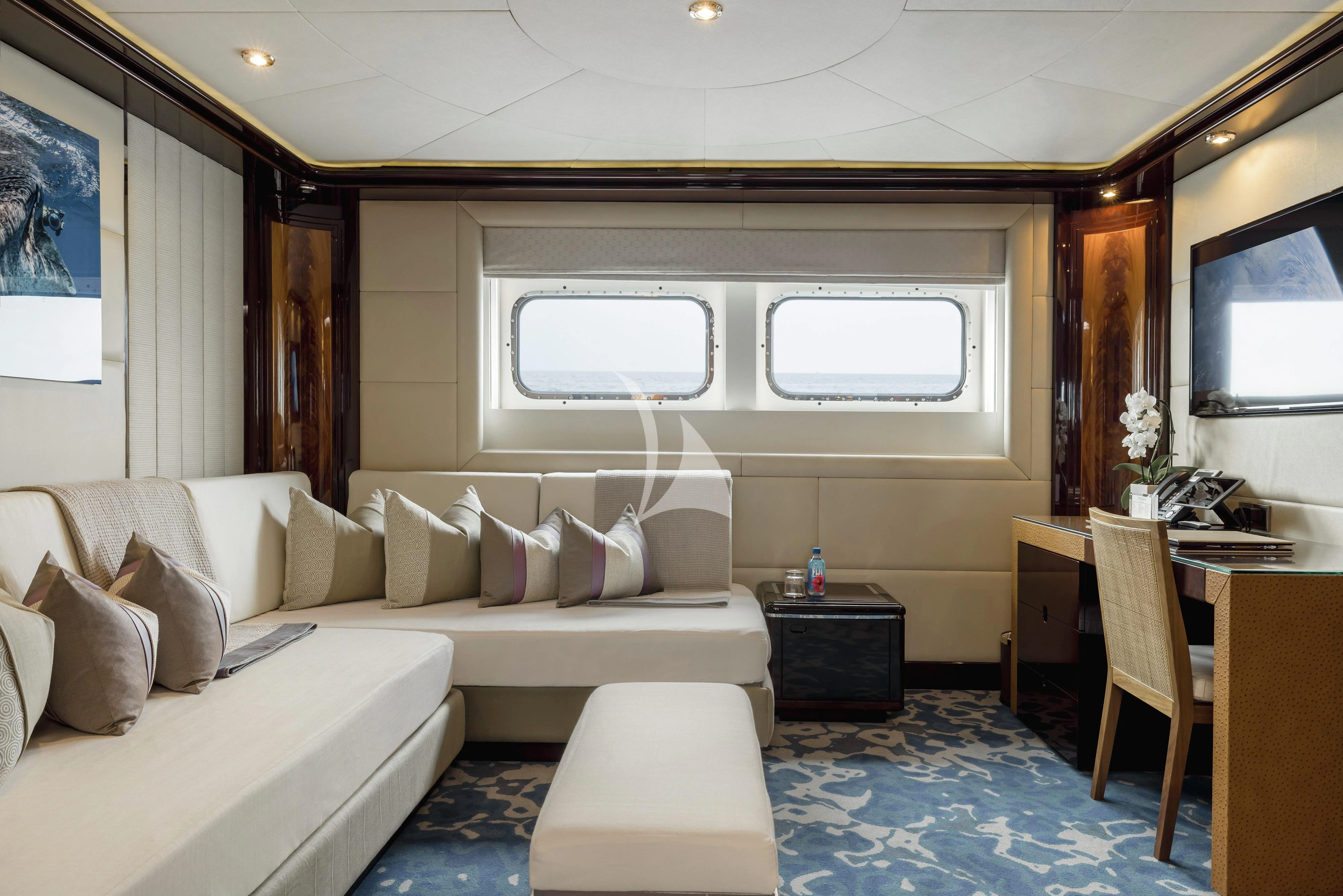 a room with a couch and a table aboard DREAM Yacht for Sale