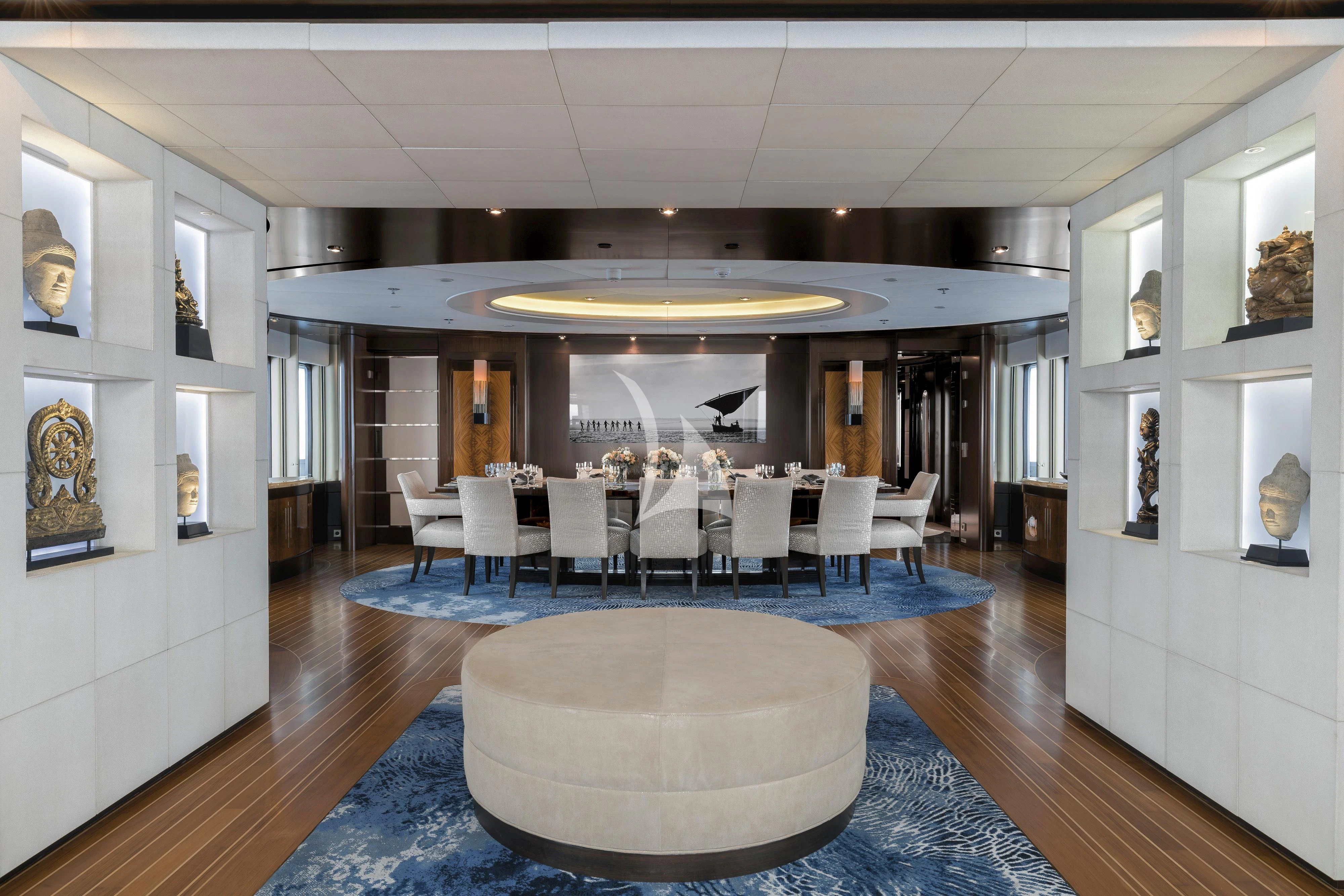 a large room with chairs and a rug aboard DREAM Yacht for Sale