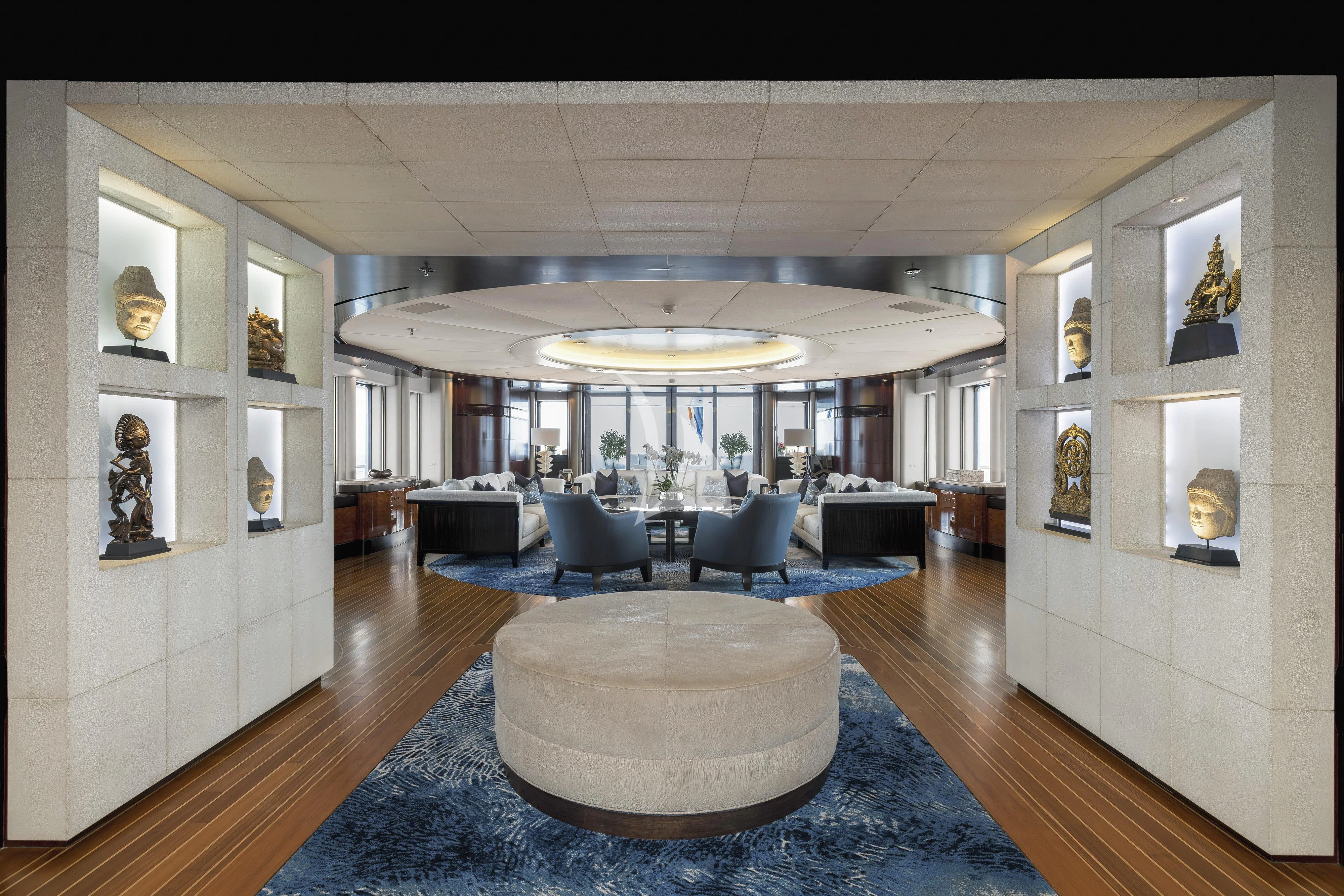 a large living room with a large blue rug aboard DREAM Yacht for Sale