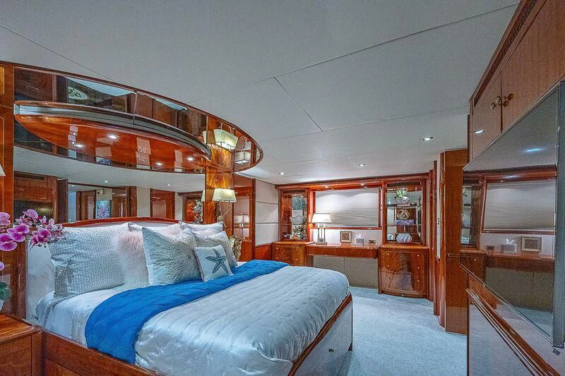 a bedroom with a bed and a mirror aboard HOPE FLOATS Yacht for Sale