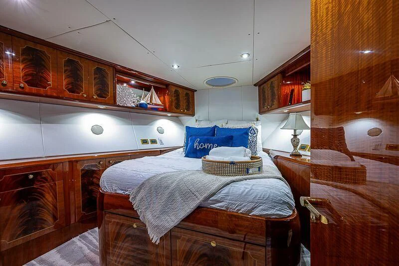 a bedroom with a bed and a desk aboard HOPE FLOATS Yacht for Sale