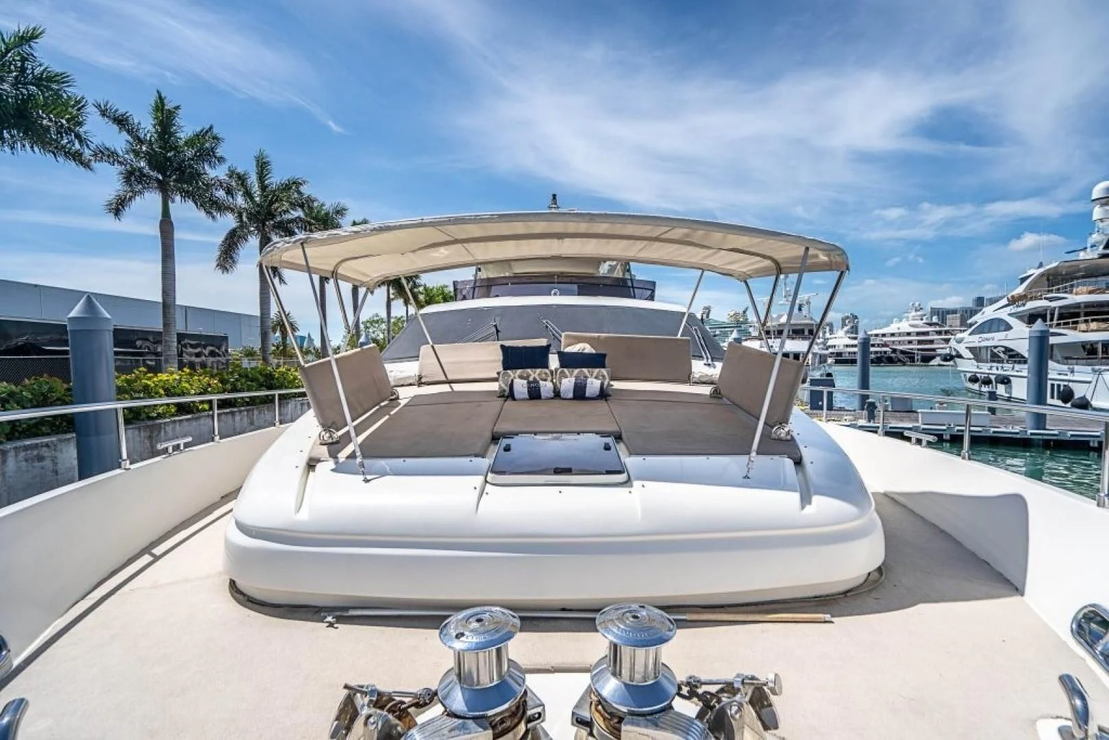 a white boat on a beach aboard INDULGE II Yacht for Sale