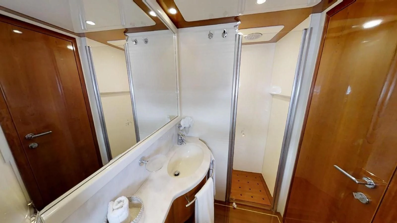 a bathroom with a large mirror aboard INDULGE II Yacht for Sale