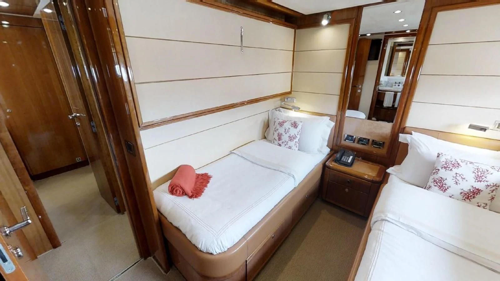 a room with a bed and a mirror aboard INDULGE II Yacht for Sale
