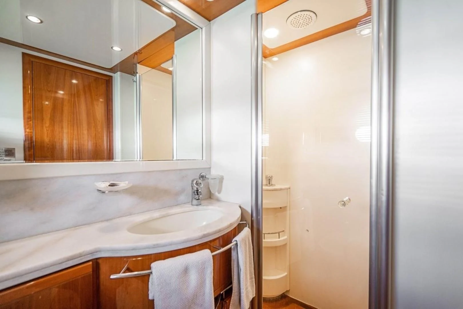 a bathroom with a sink and a mirror aboard INDULGE II Yacht for Sale