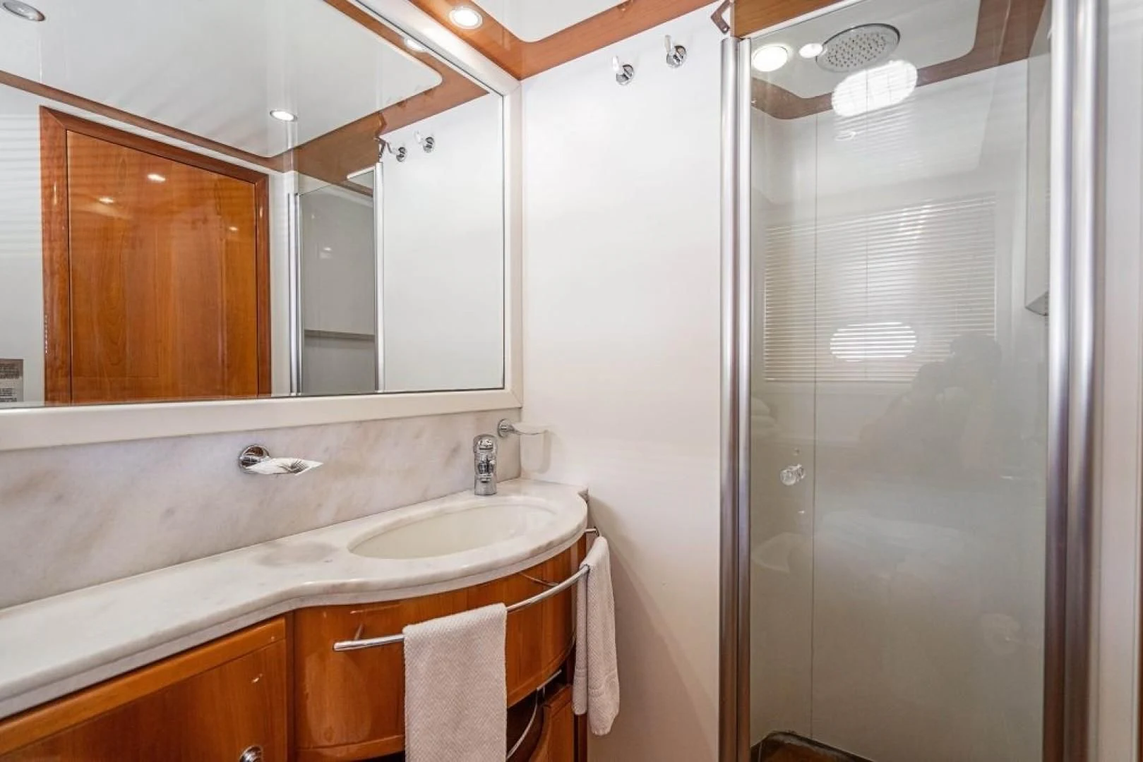 a bathroom with a sink and a shower aboard INDULGE II Yacht for Sale