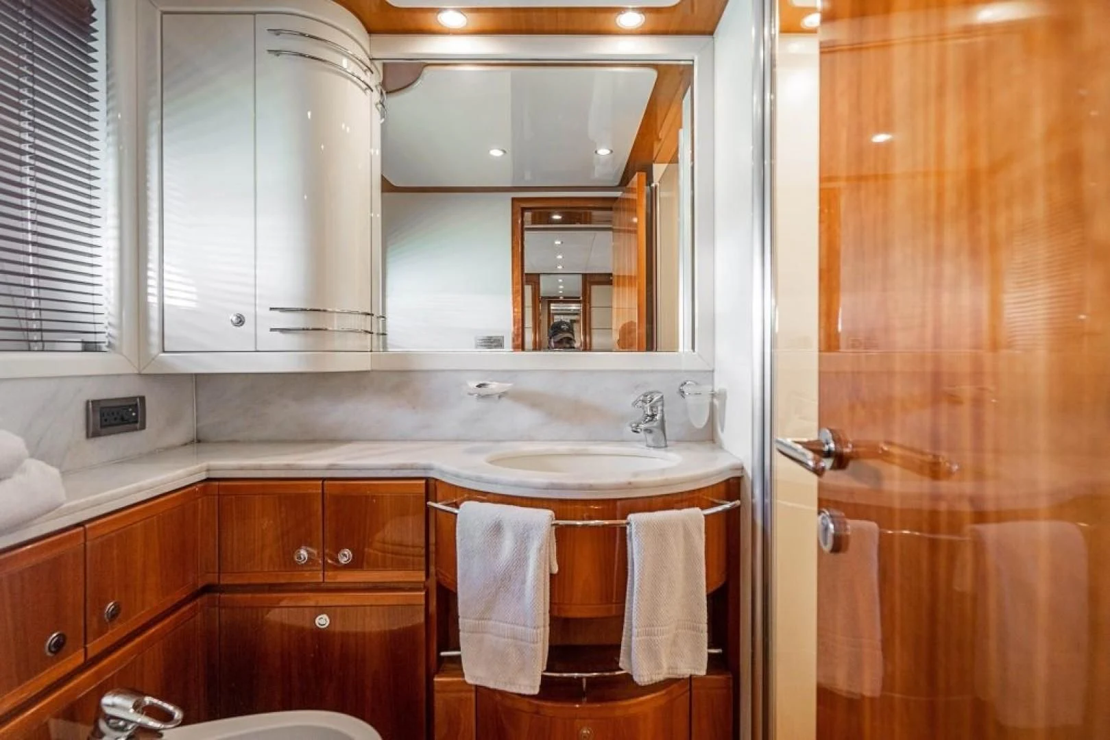 a bathroom with a sink and cabinets aboard INDULGE II Yacht for Sale