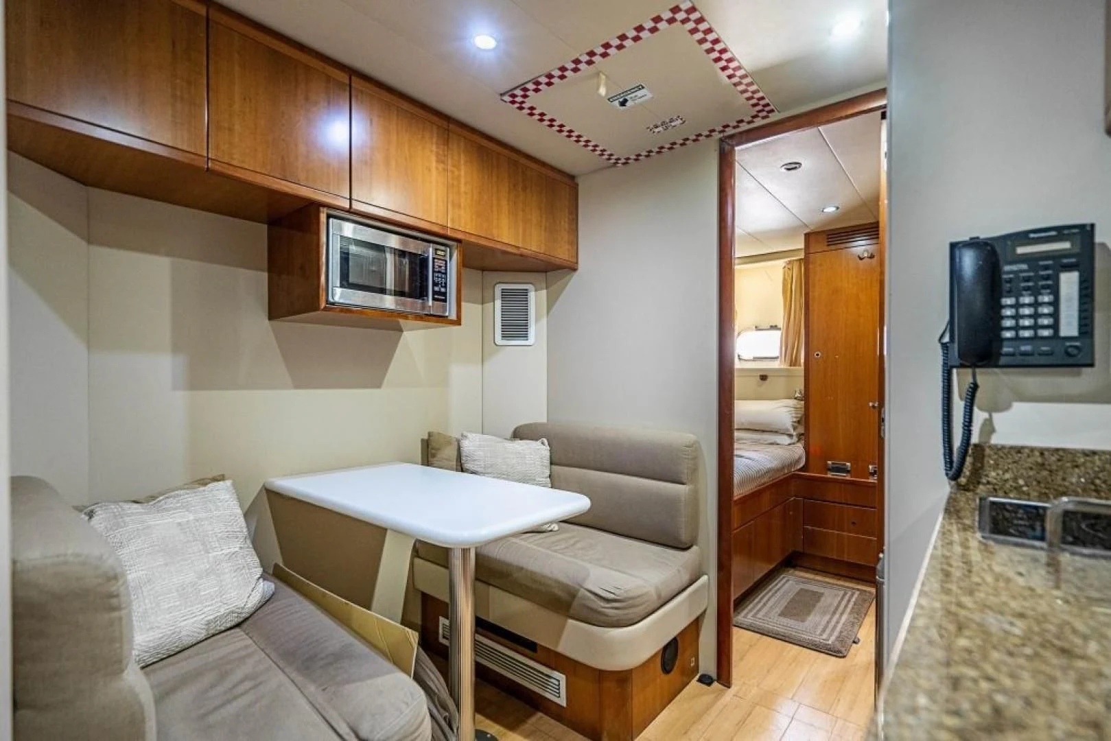 a living room with a table and couches aboard INDULGE II Yacht for Sale