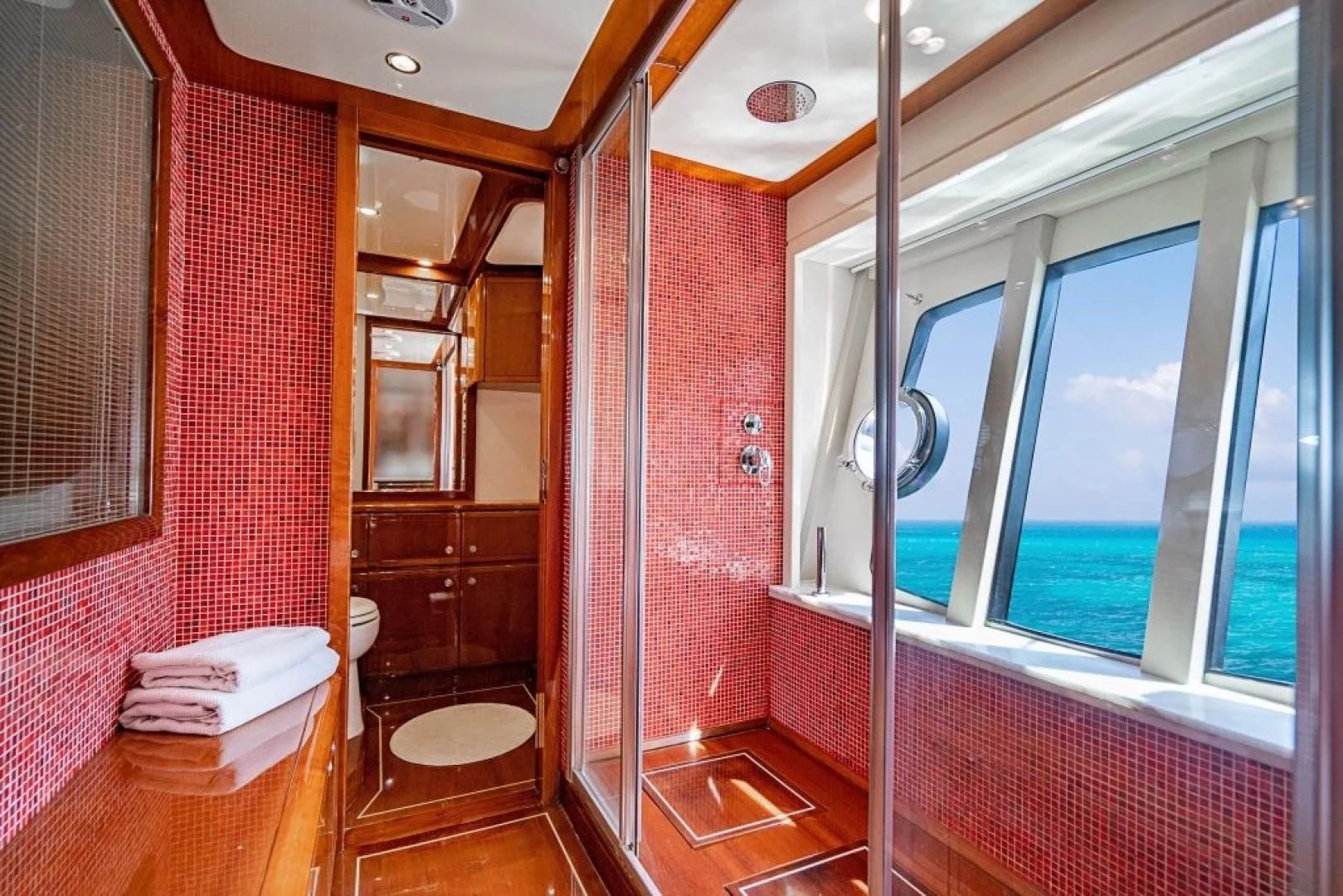 a bathroom with red walls aboard INDULGE II Yacht for Sale