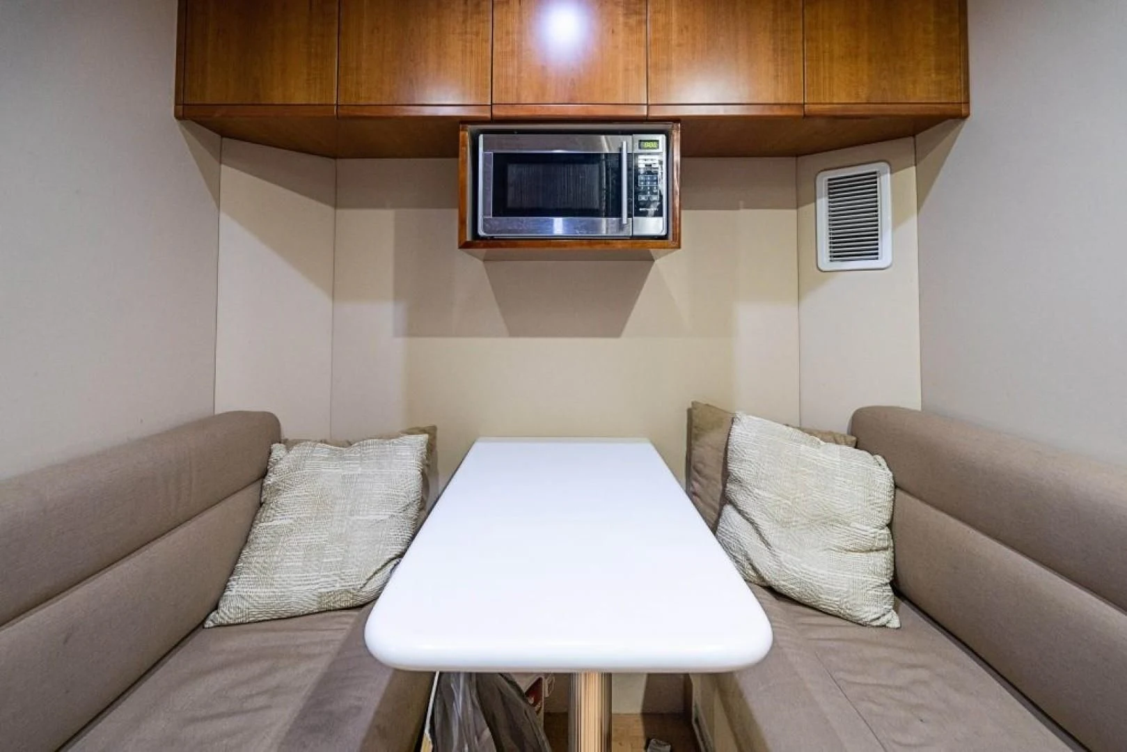 a living room with a couch and a table aboard INDULGE II Yacht for Sale