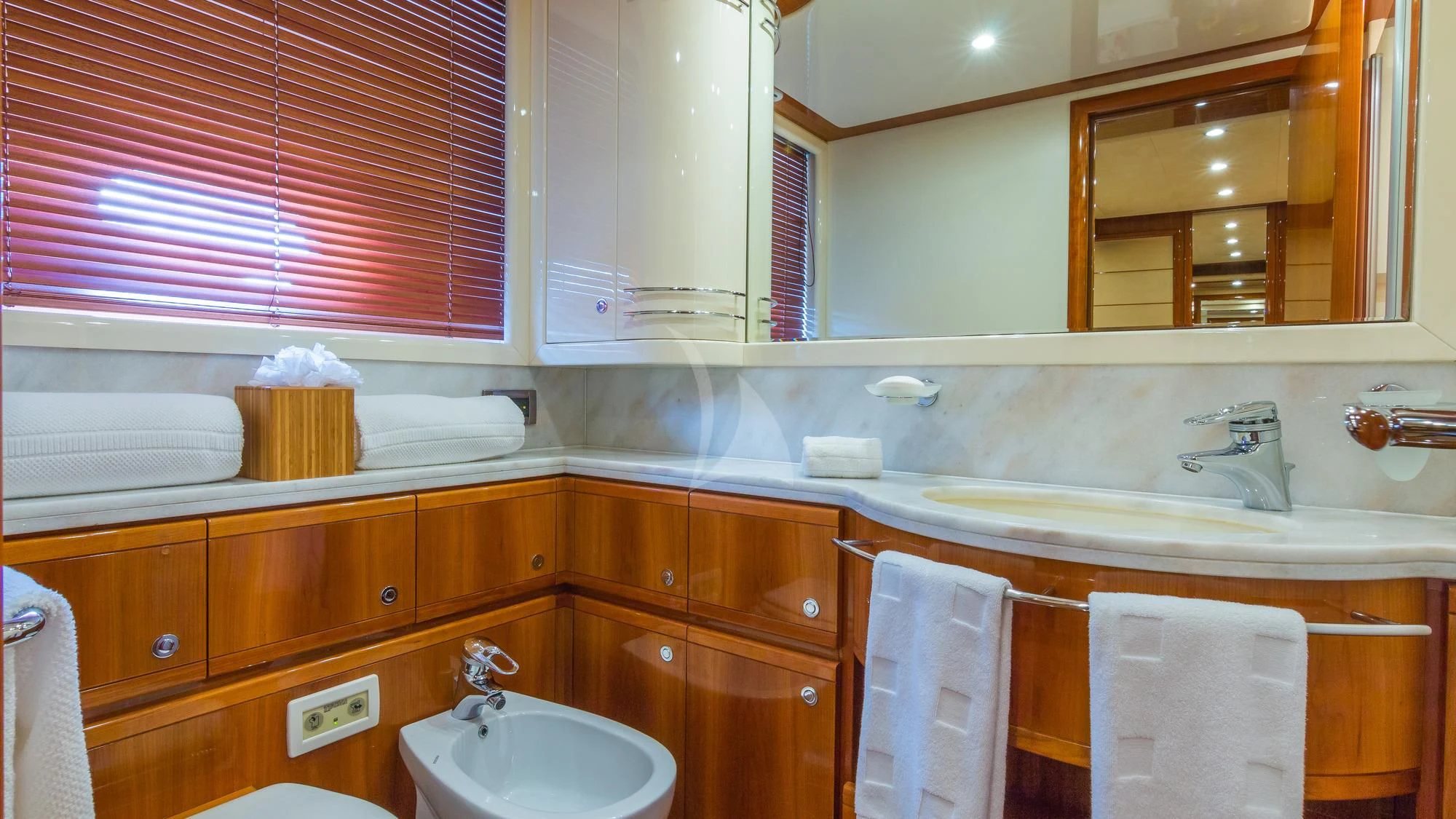 a bathroom with a sink and a mirror aboard INDULGE II Yacht for Sale