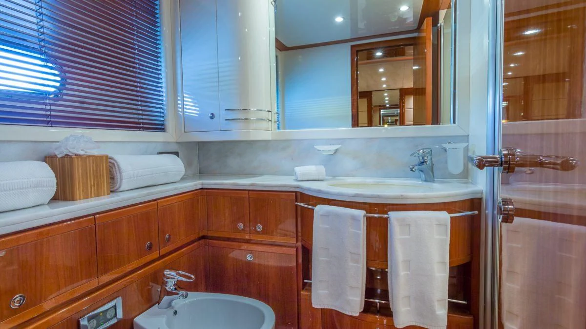 a bathroom with a sink and cabinets aboard INDULGE II Yacht for Sale