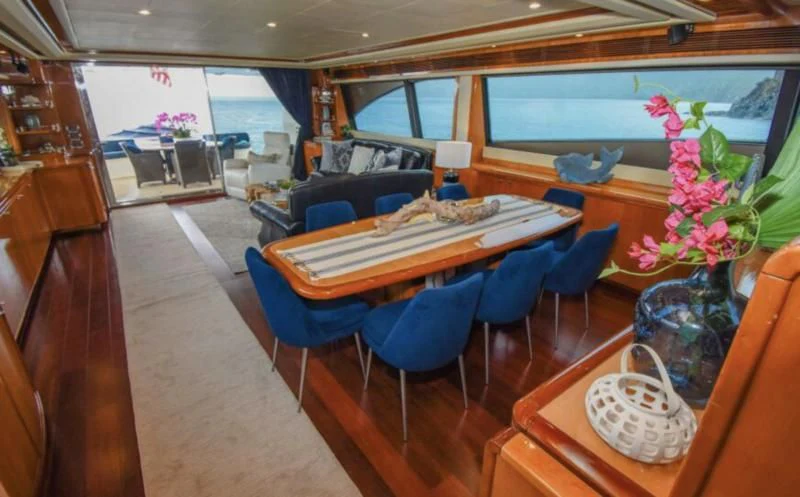 a room with a table and chairs aboard INDULGE II Yacht for Sale