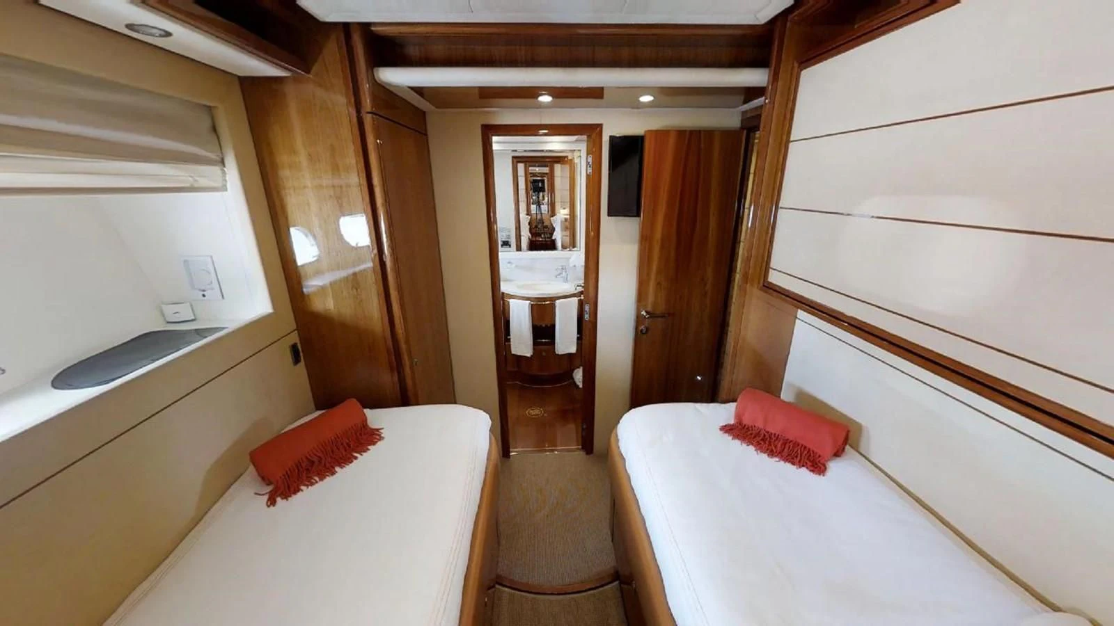 a room with a bed and a mirror aboard INDULGE II Yacht for Sale