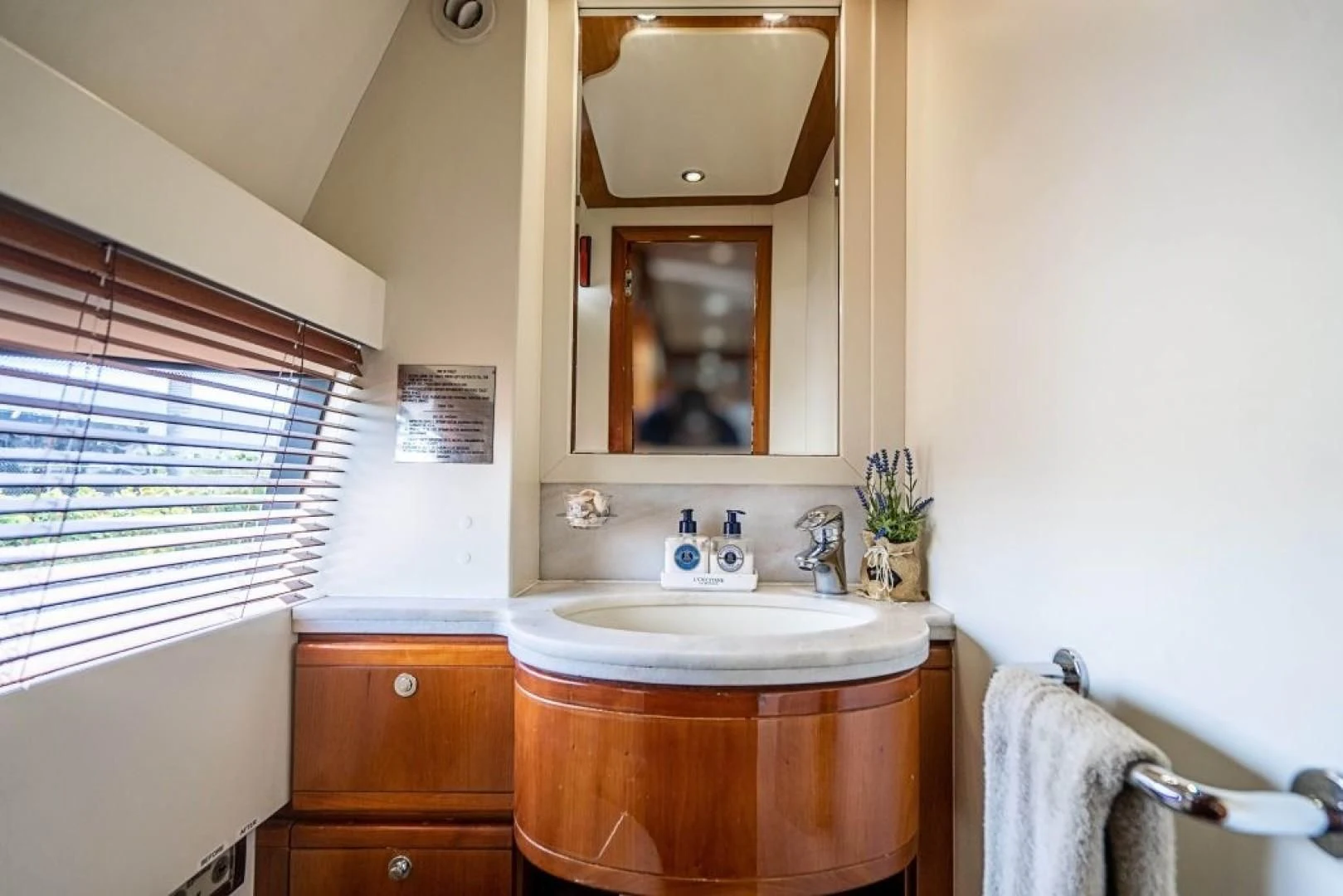 a bathroom with a sink and a mirror aboard INDULGE II Yacht for Sale
