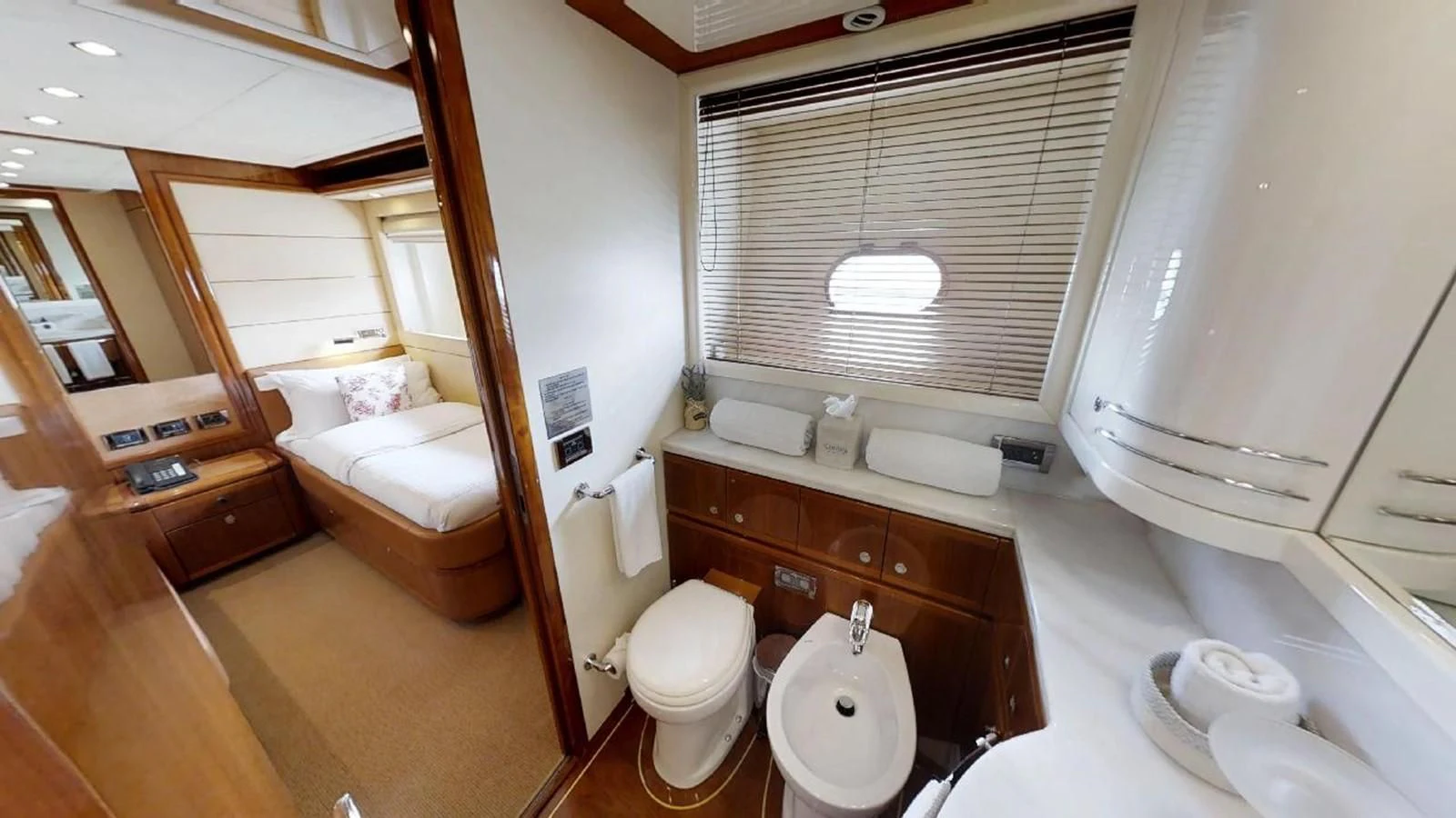 a bathroom with a toilet and a sink aboard INDULGE II Yacht for Sale