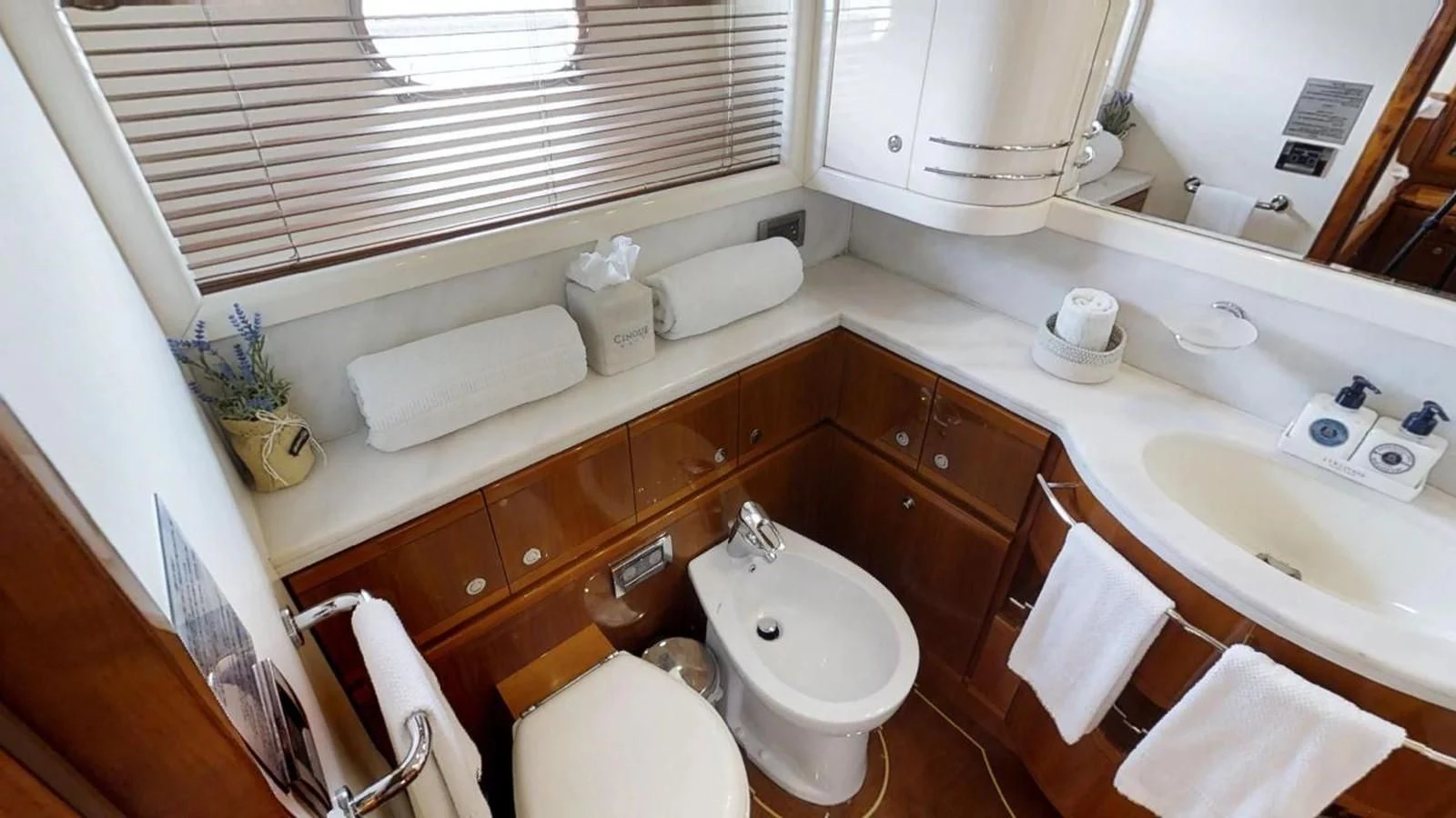 a bathroom with a sink and toilet aboard INDULGE II Yacht for Sale