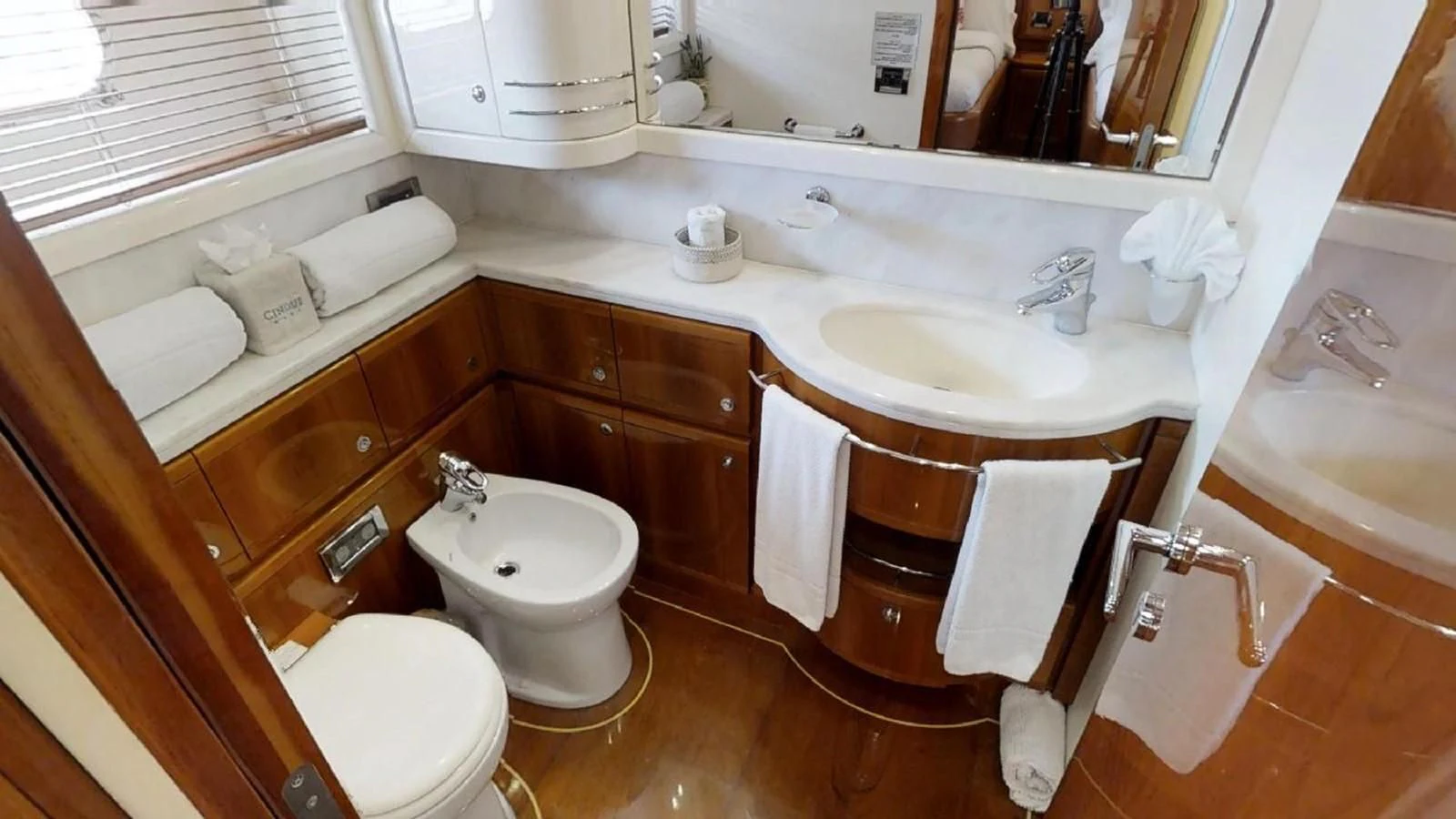 a bathroom with a sink and a toilet aboard INDULGE II Yacht for Sale