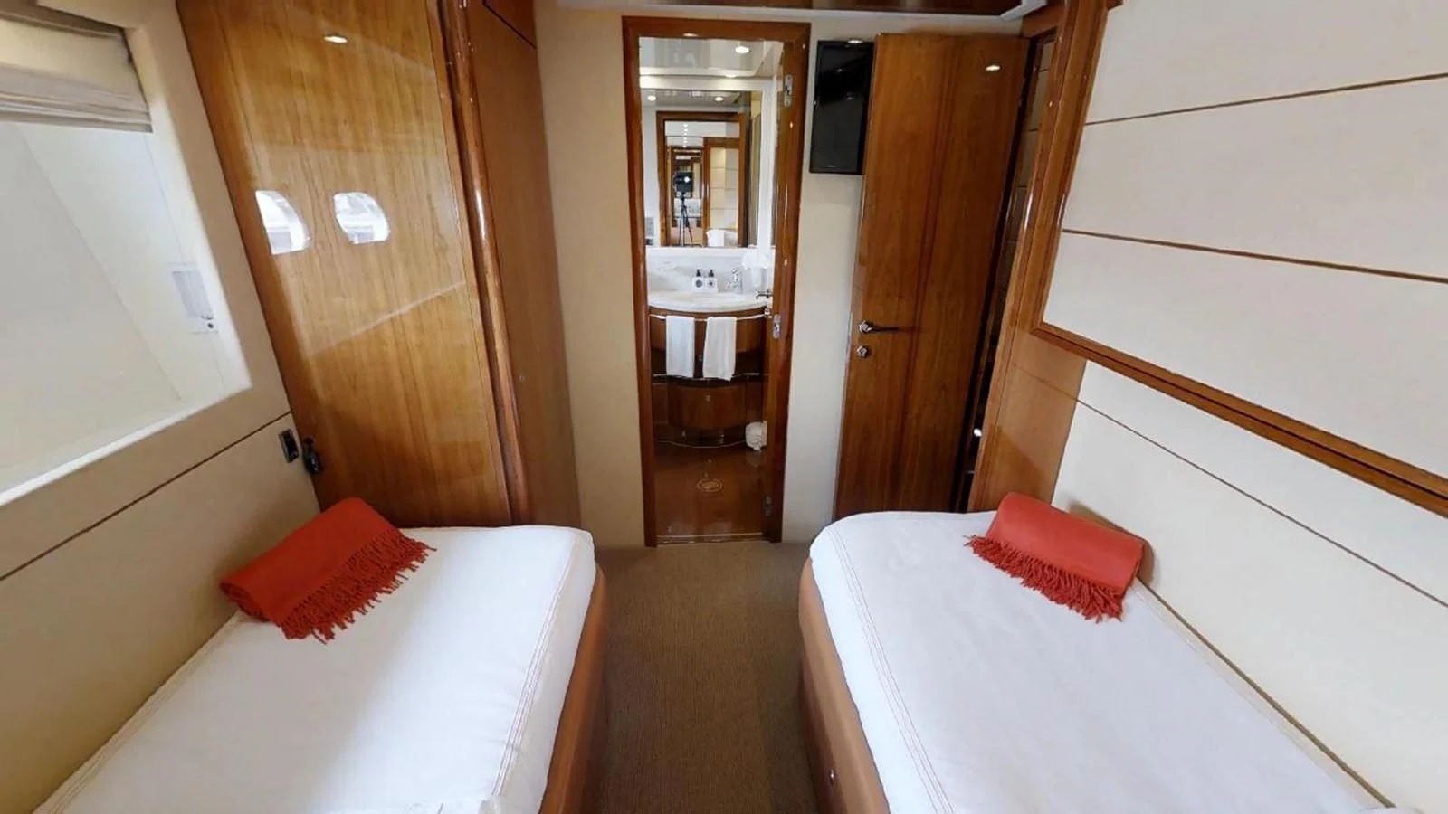 a room with a bed and a mirror aboard INDULGE II Yacht for Sale