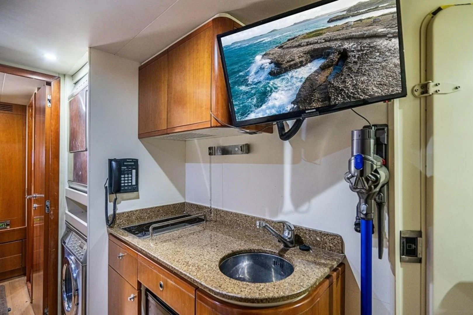 a kitchen with a sink and a fan aboard INDULGE II Yacht for Sale