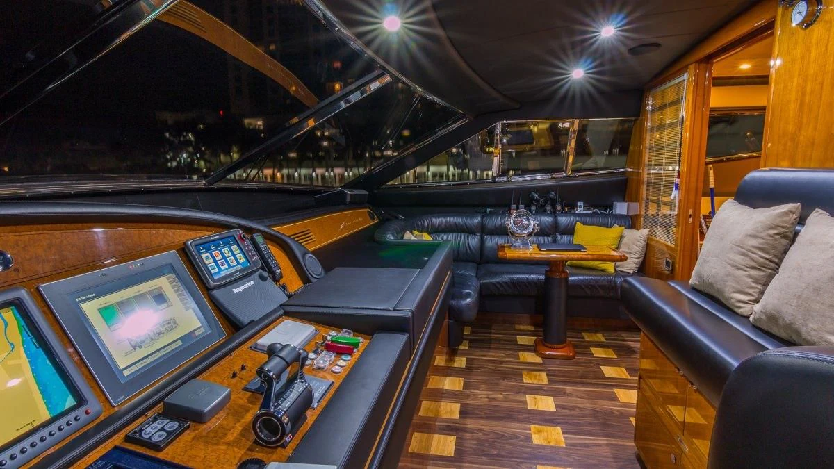 a room with a table and a tv aboard INDULGE II Yacht for Sale