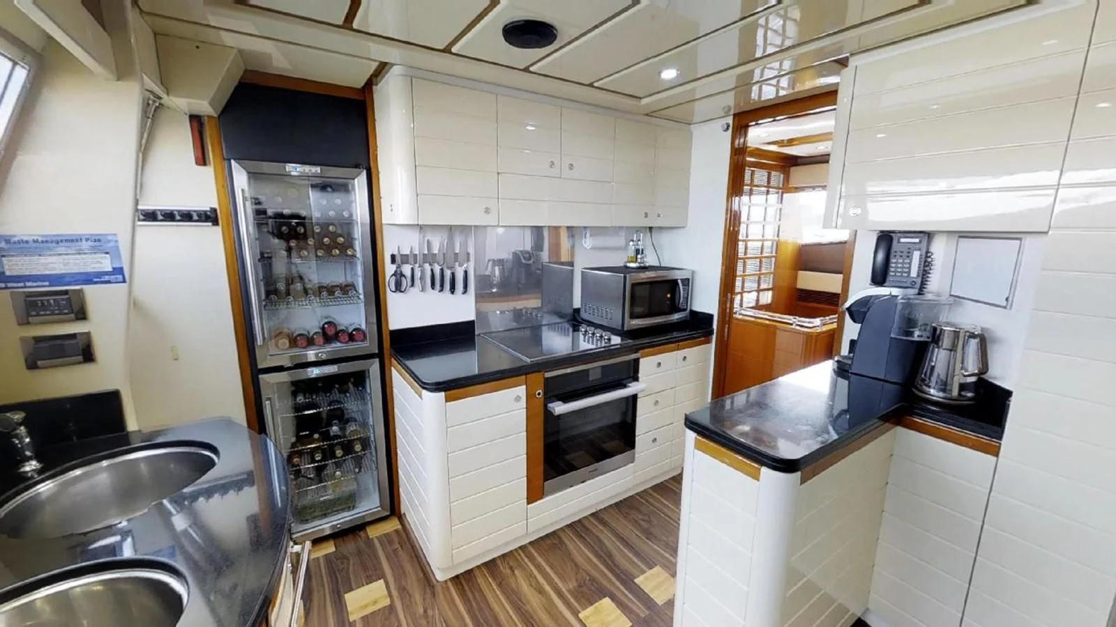 a kitchen with a refrigerator and a sink aboard INDULGE II Yacht for Sale