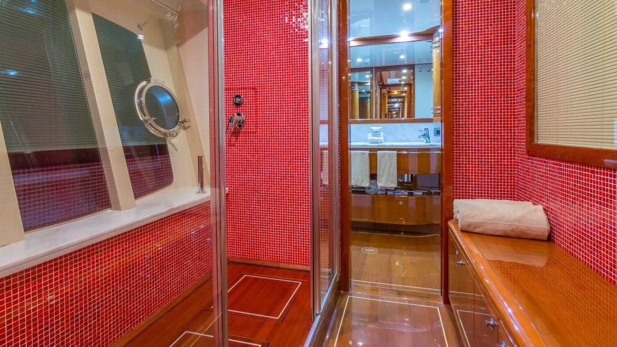 a room with a mirror and a bench aboard INDULGE II Yacht for Sale