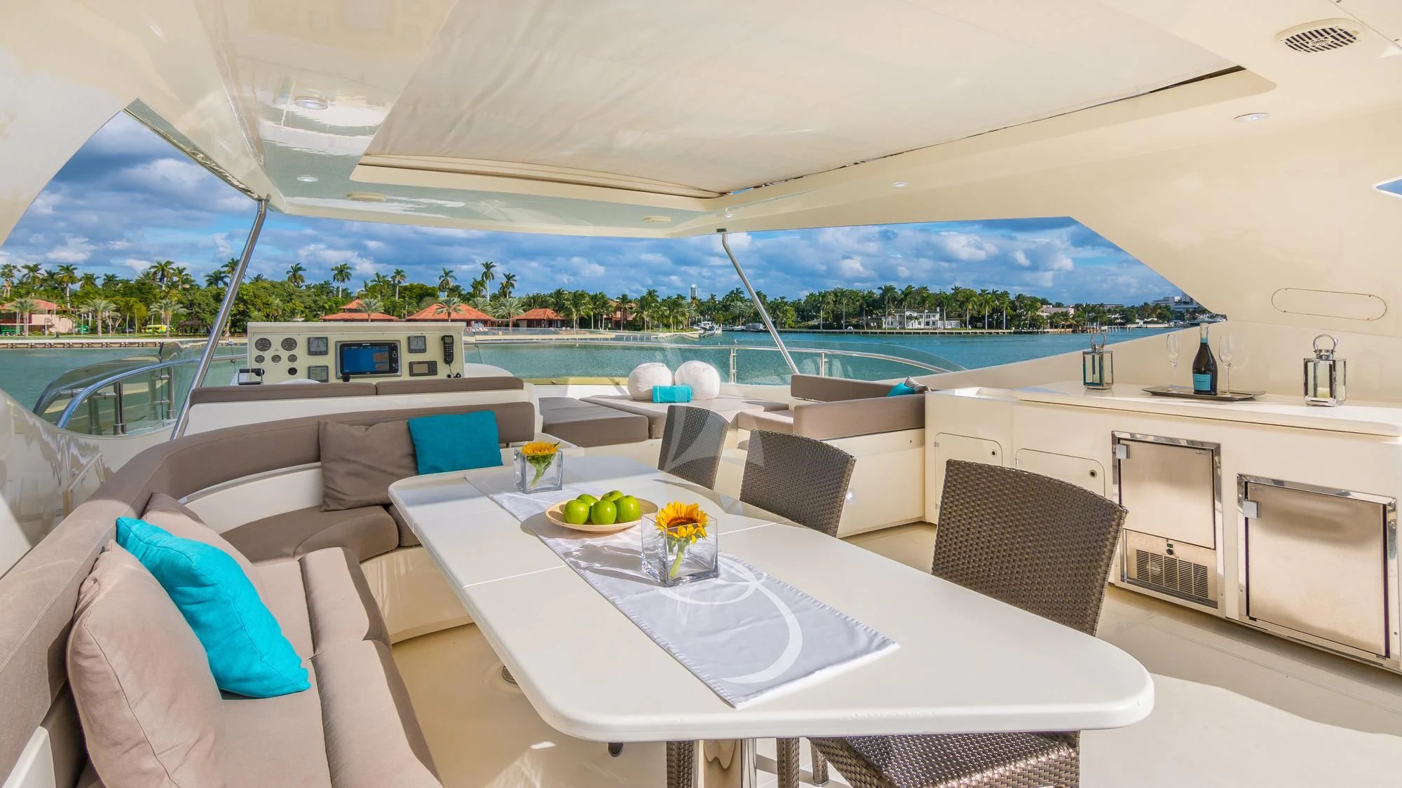 a large white lounge chair next to a large white table with a white table and chairs on it aboard INDULGE II Yacht for Sale
