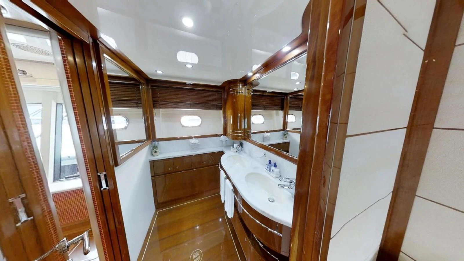 a bathroom with a sink and a mirror aboard INDULGE II Yacht for Sale