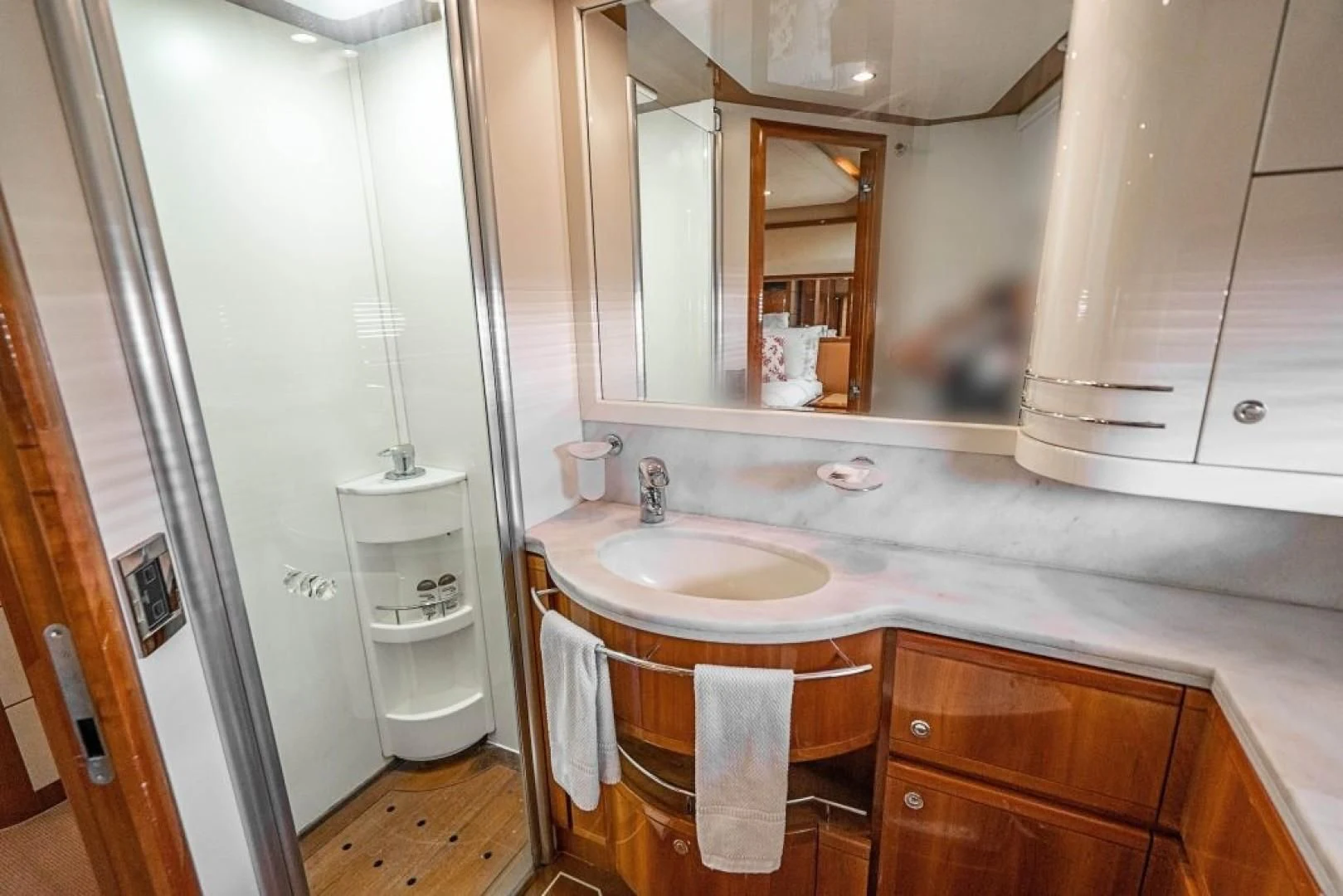a bathroom with a sink and a mirror aboard INDULGE II Yacht for Sale