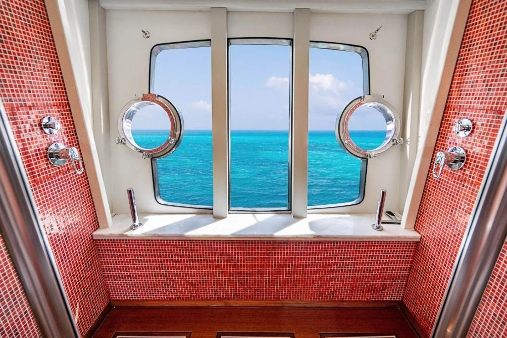 a window with a view of the ocean aboard INDULGE II Yacht for Sale