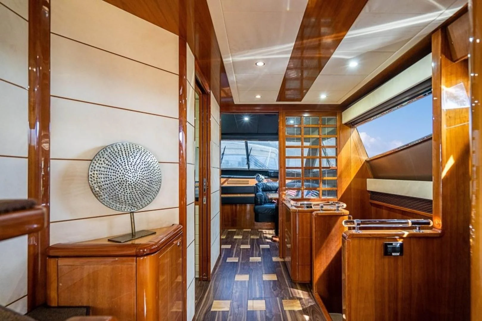 a room with wood floors and a fan aboard INDULGE II Yacht for Sale