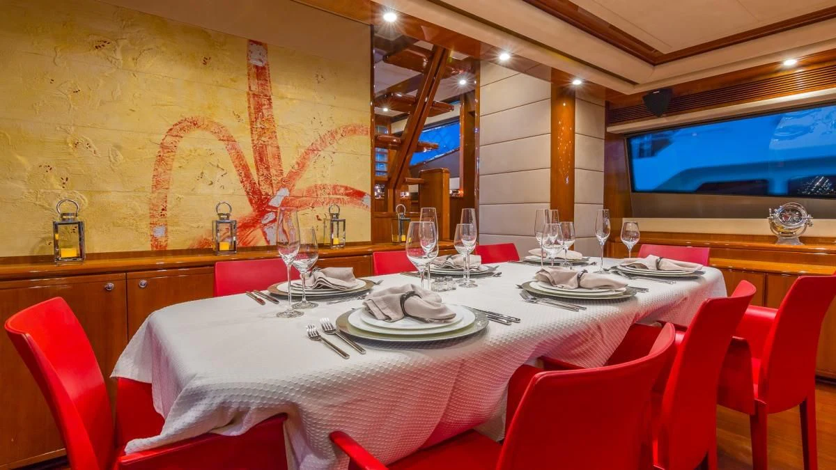 a table set for a dinner aboard INDULGE II Yacht for Sale