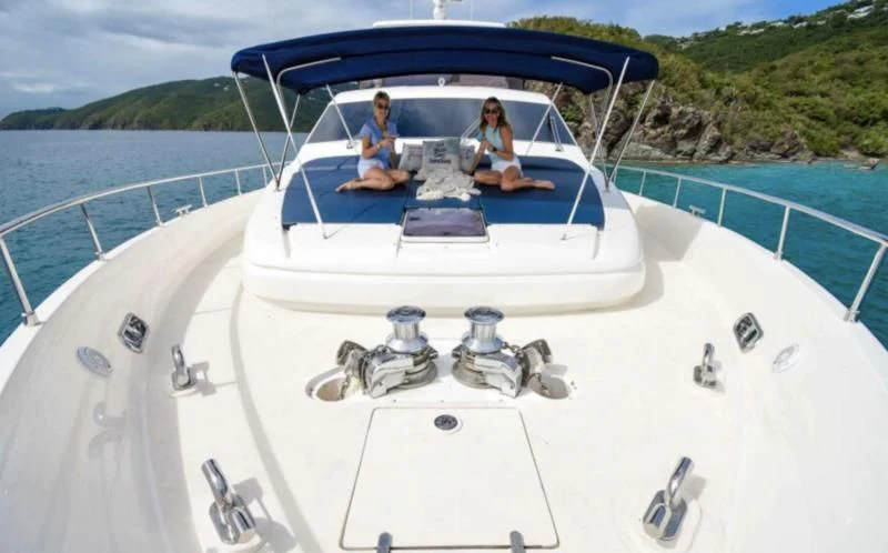 a couple of people on a boat aboard INDULGE II Yacht for Sale