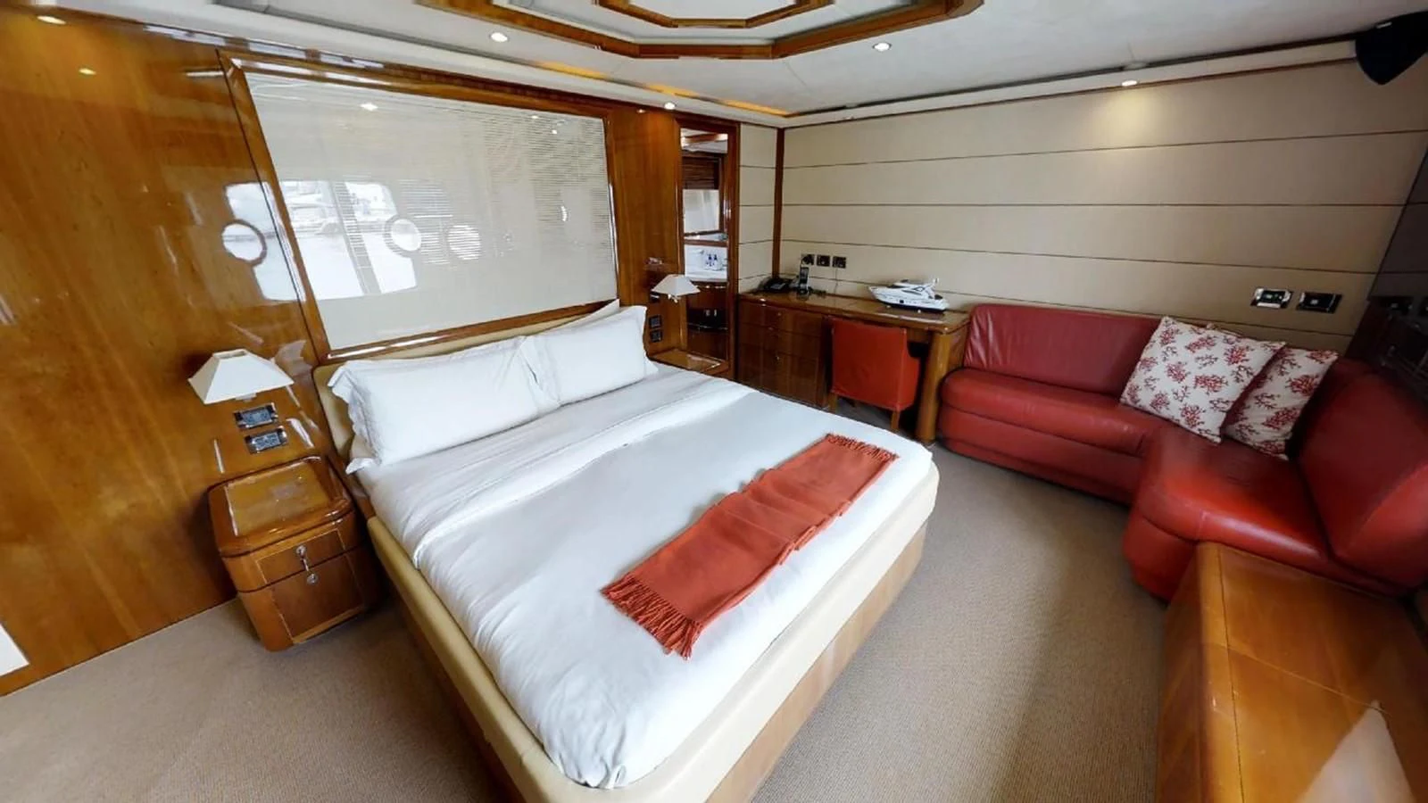 a bedroom with a bed and a couch aboard INDULGE II Yacht for Sale