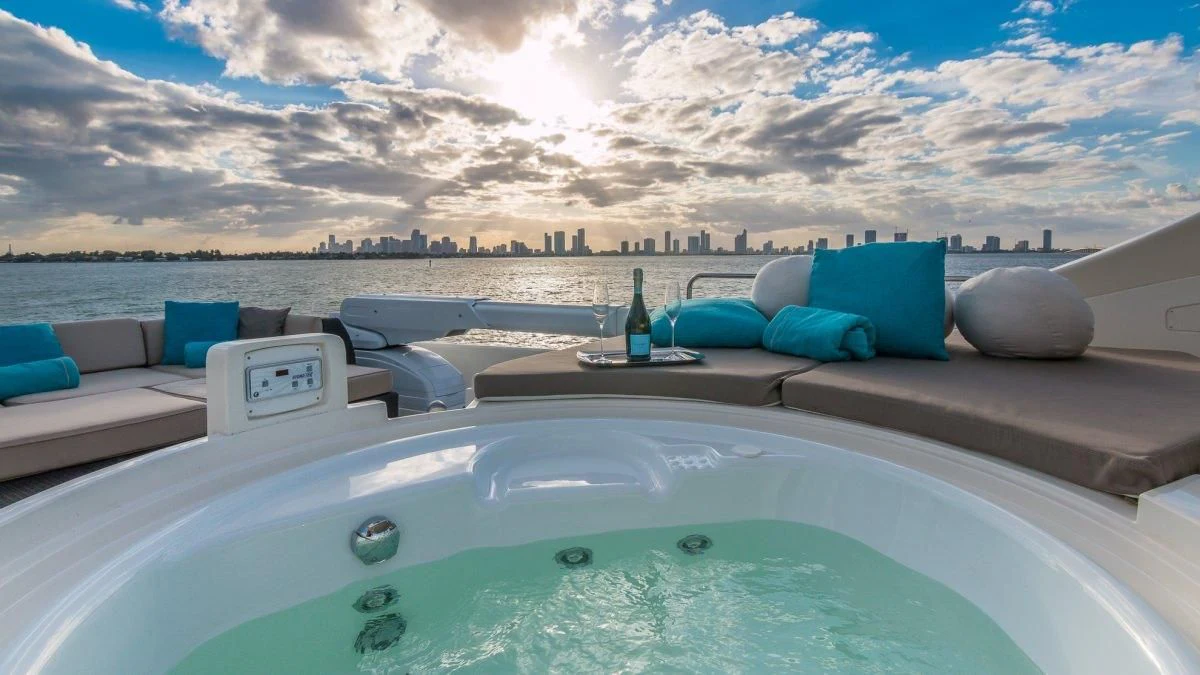 a pool with a bottle and a view of a city aboard INDULGE II Yacht for Sale
